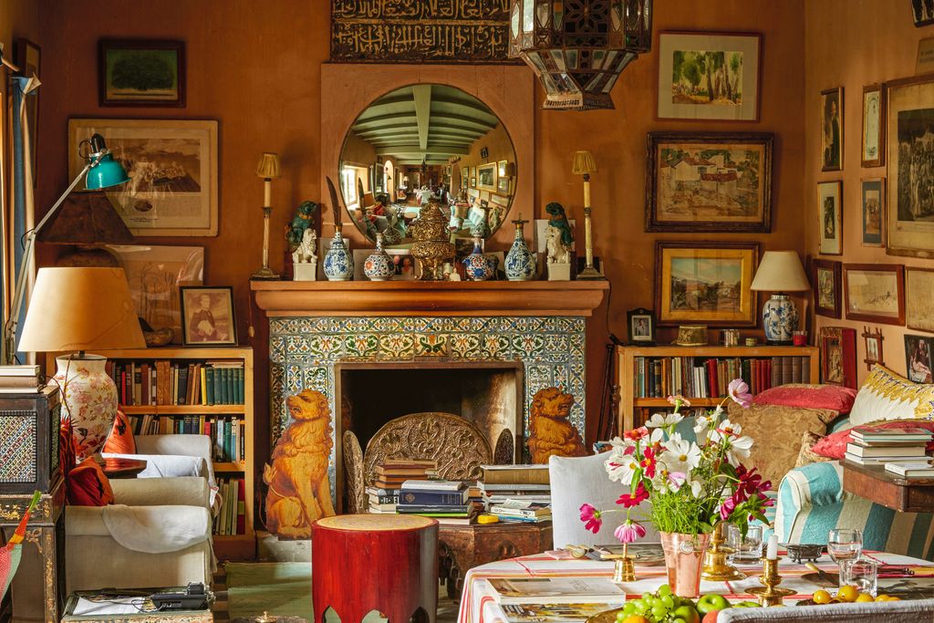 Image may contain Home Decor Lamp Architecture Building Furniture Indoors Living Room Room Fireplace and Art