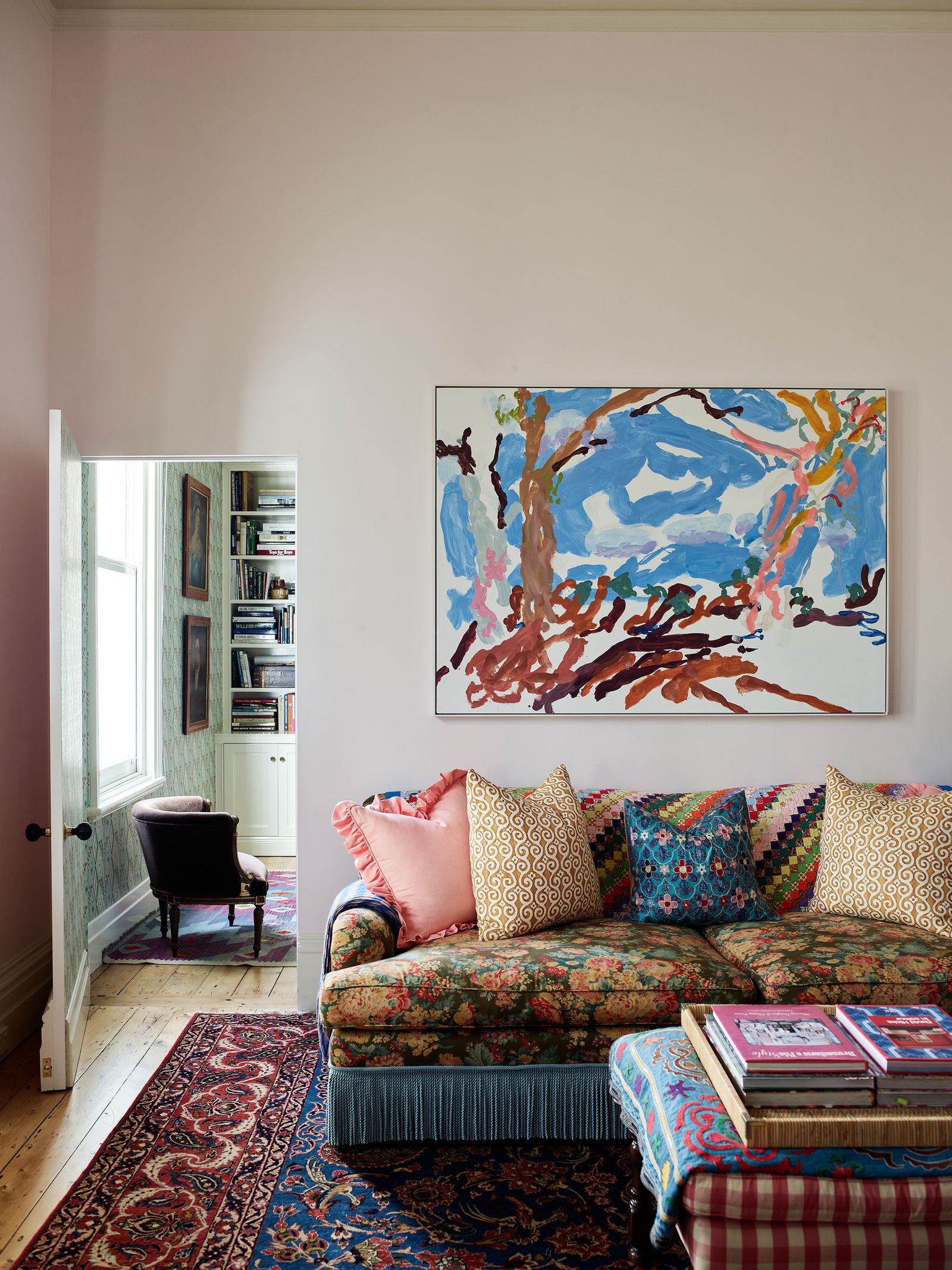 Image may contain Home Decor Architecture Building Furniture Indoors Living Room Room Couch Cushion Rug and Art