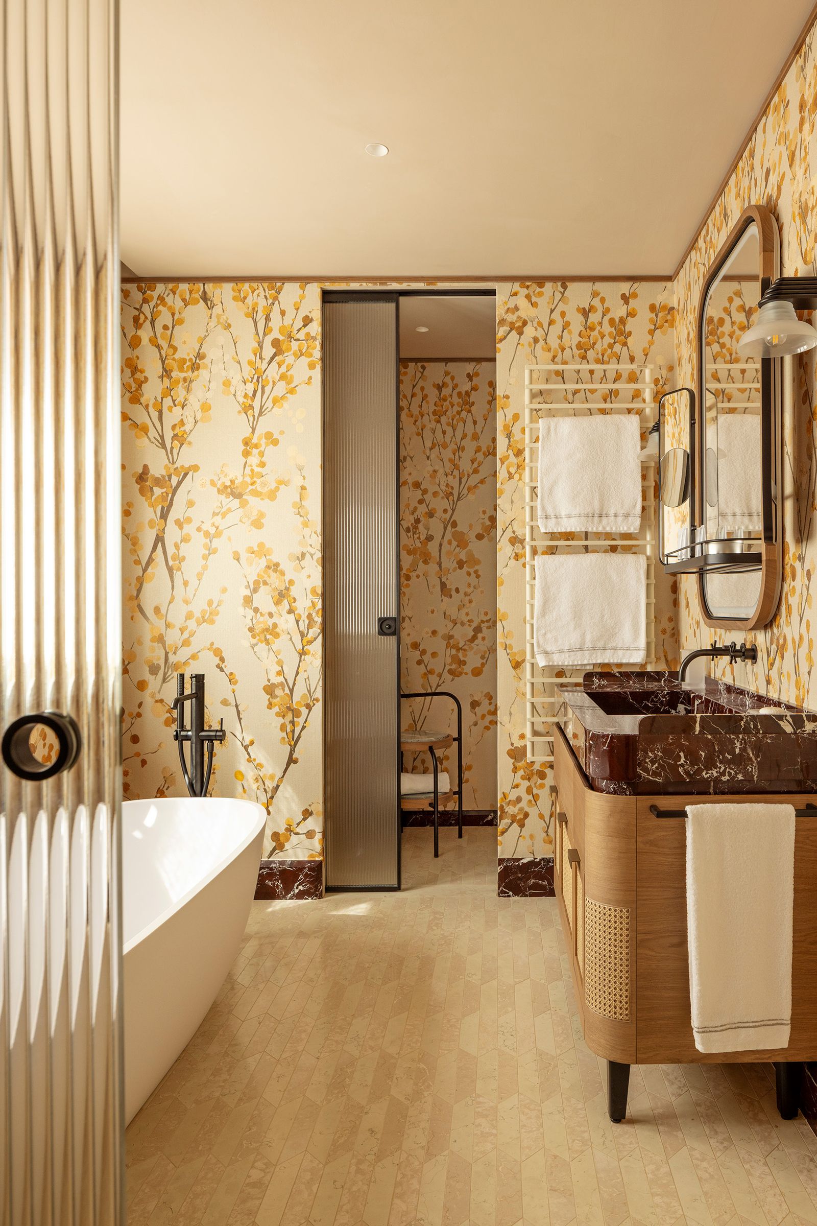 Image may contain Indoors Interior Design Bathing Bathtub Person Tub Sink Sink Faucet Chair and Furniture