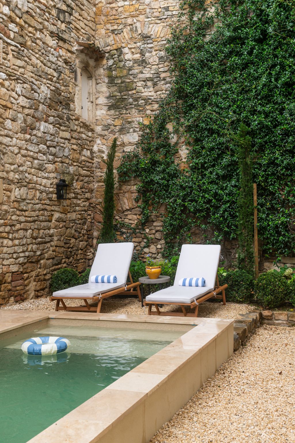 Image may contain Chair Furniture Backyard Nature Outdoors Yard Pool Water Plant and Swimming Pool