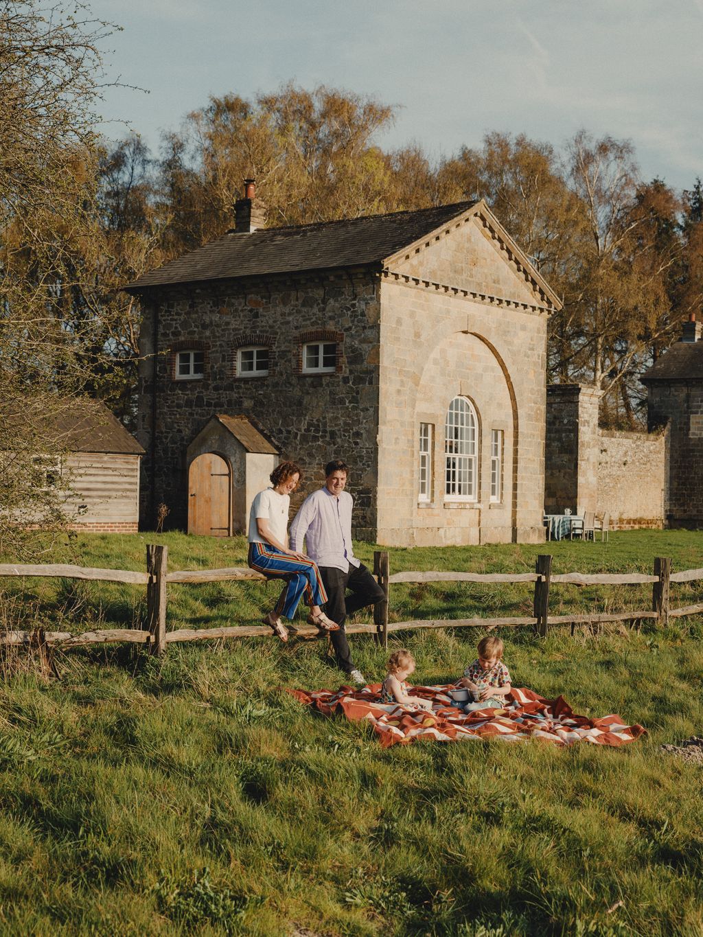 Image may contain Architecture Building Outdoors Shelter Grass Plant Person Teen Accessories Bag and Handbag