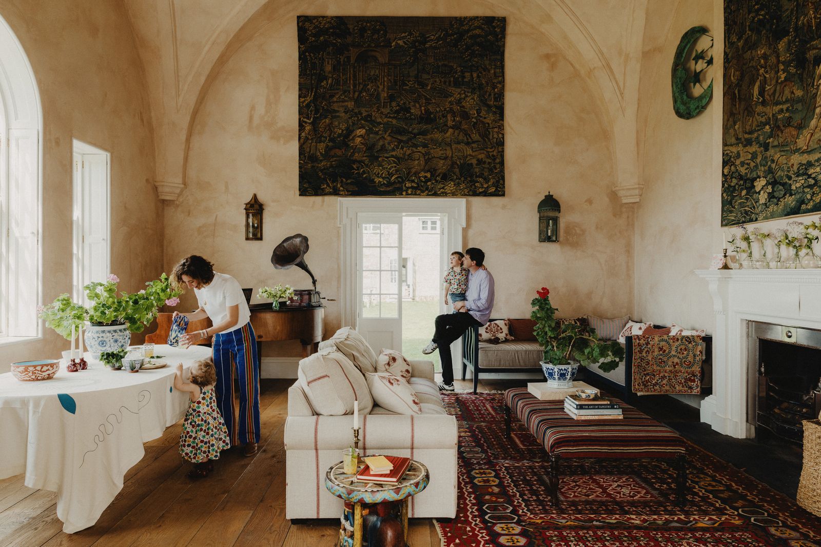 Image may contain Home Decor Book Publication Couch Furniture Adult Person Rug Table Clothing Footwear and Shoe