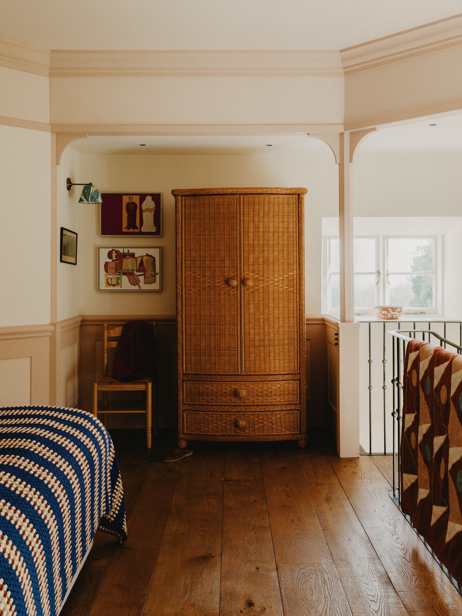 Image may contain Indoors Interior Design Chair Furniture Lamp Wood Art Painting Clothing Footwear Shoe and Couch