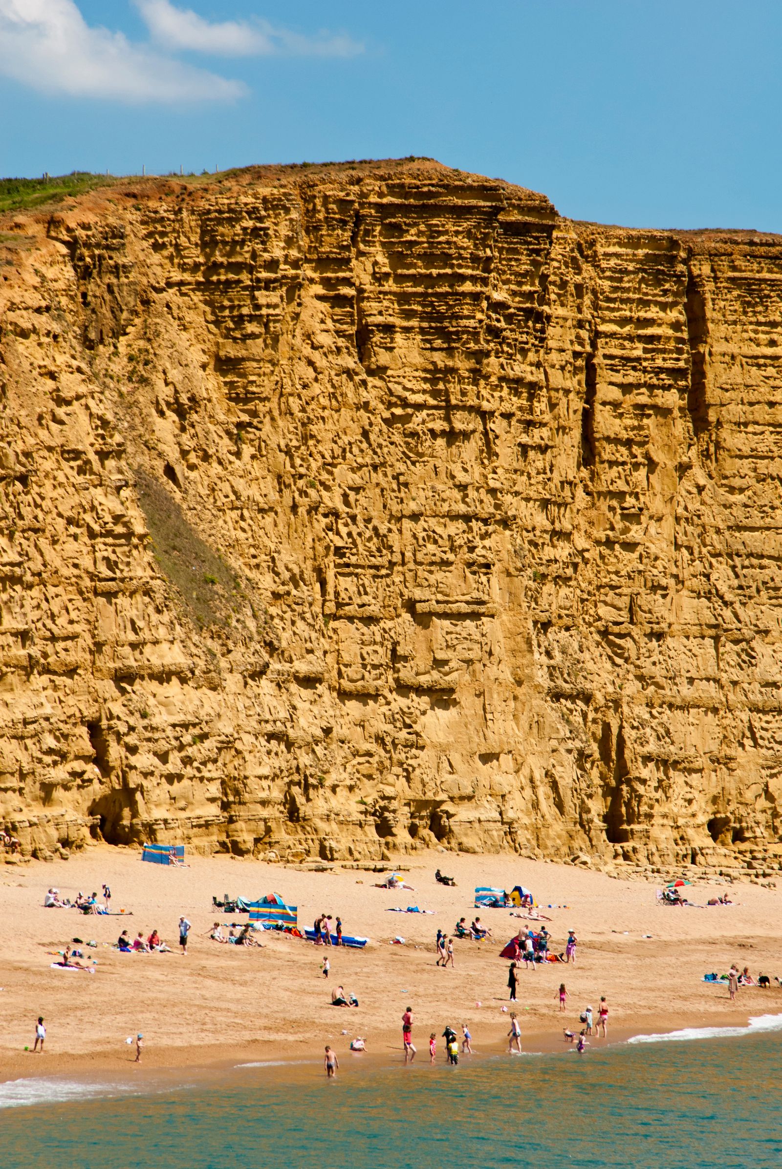 Image may contain Cliff Nature Outdoors Beach Coast Sea Shoreline Water Person Summer Scenery and Rock