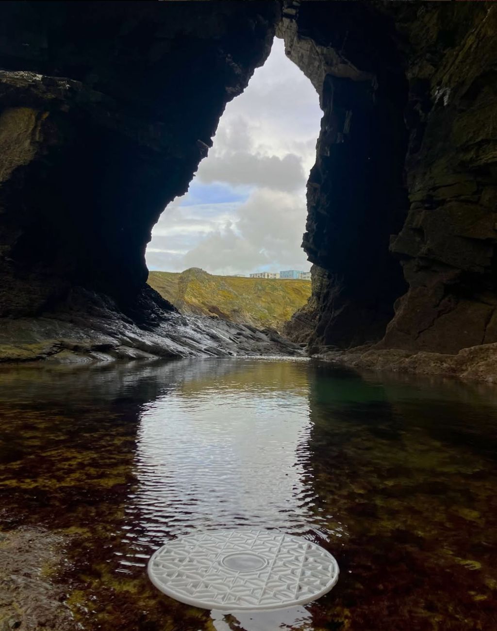Image may contain Lake Nature Outdoors Water Lagoon Scenery Cave Sky Rock Coast Cove Sea and Shoreline