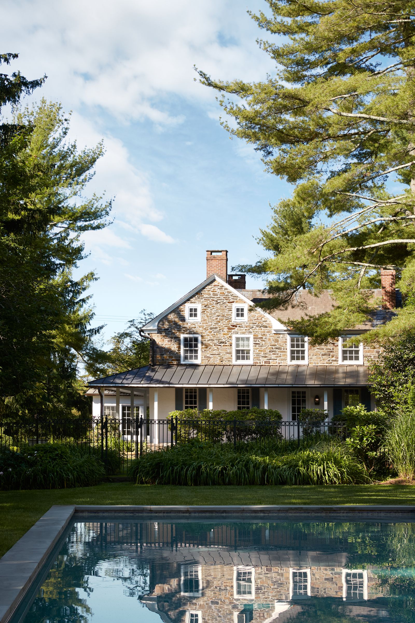 Image may contain Architecture Building House Housing Villa Nature Outdoors Scenery Plant Tree Pool and Water