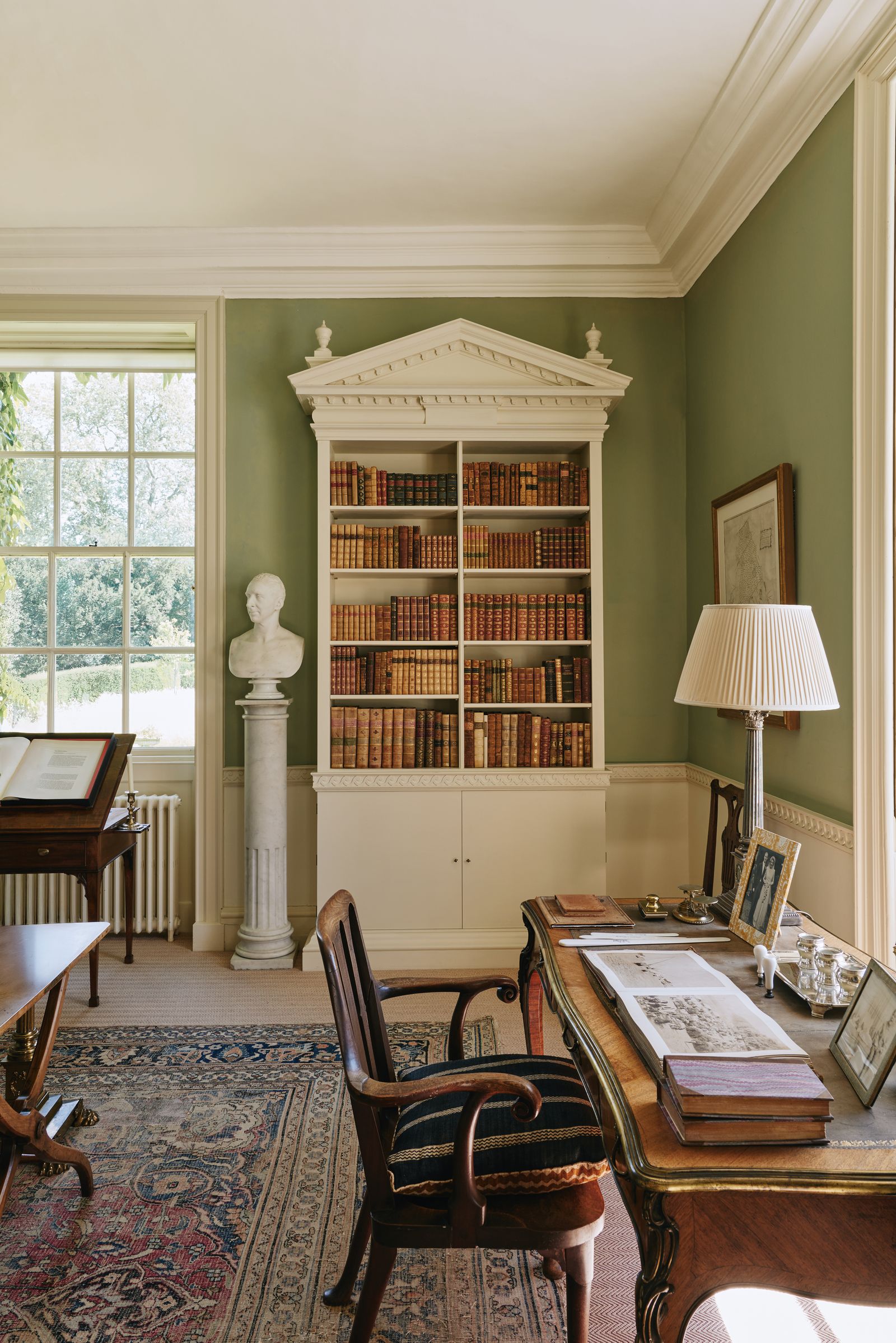 Image may contain Hugo Black Chair Furniture Lamp Desk Table Indoors Interior Design Art Painting and Person