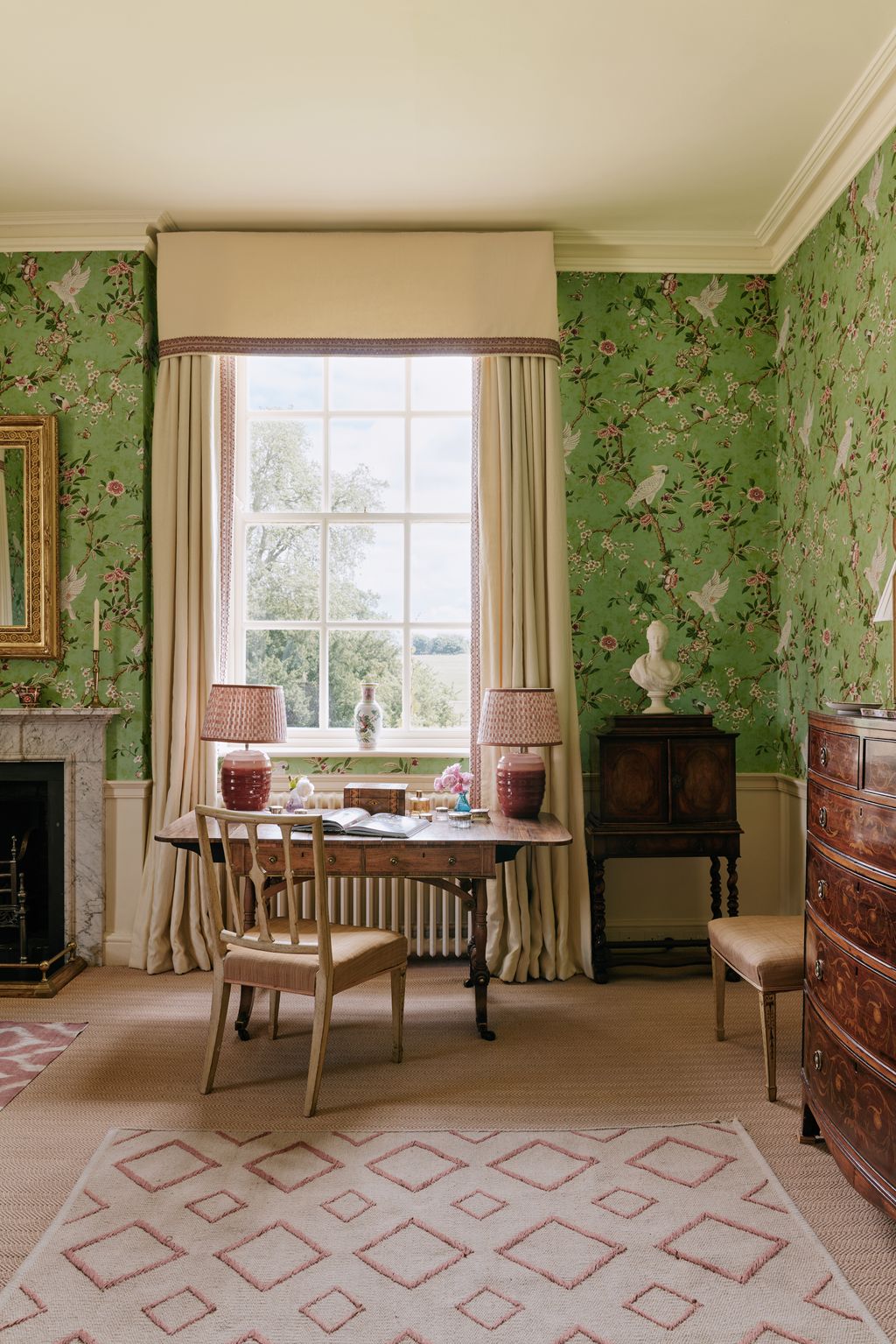 Image may contain Home Decor Lamp Desk Furniture Table Rug Chair Art Painting Person Window and Indoors