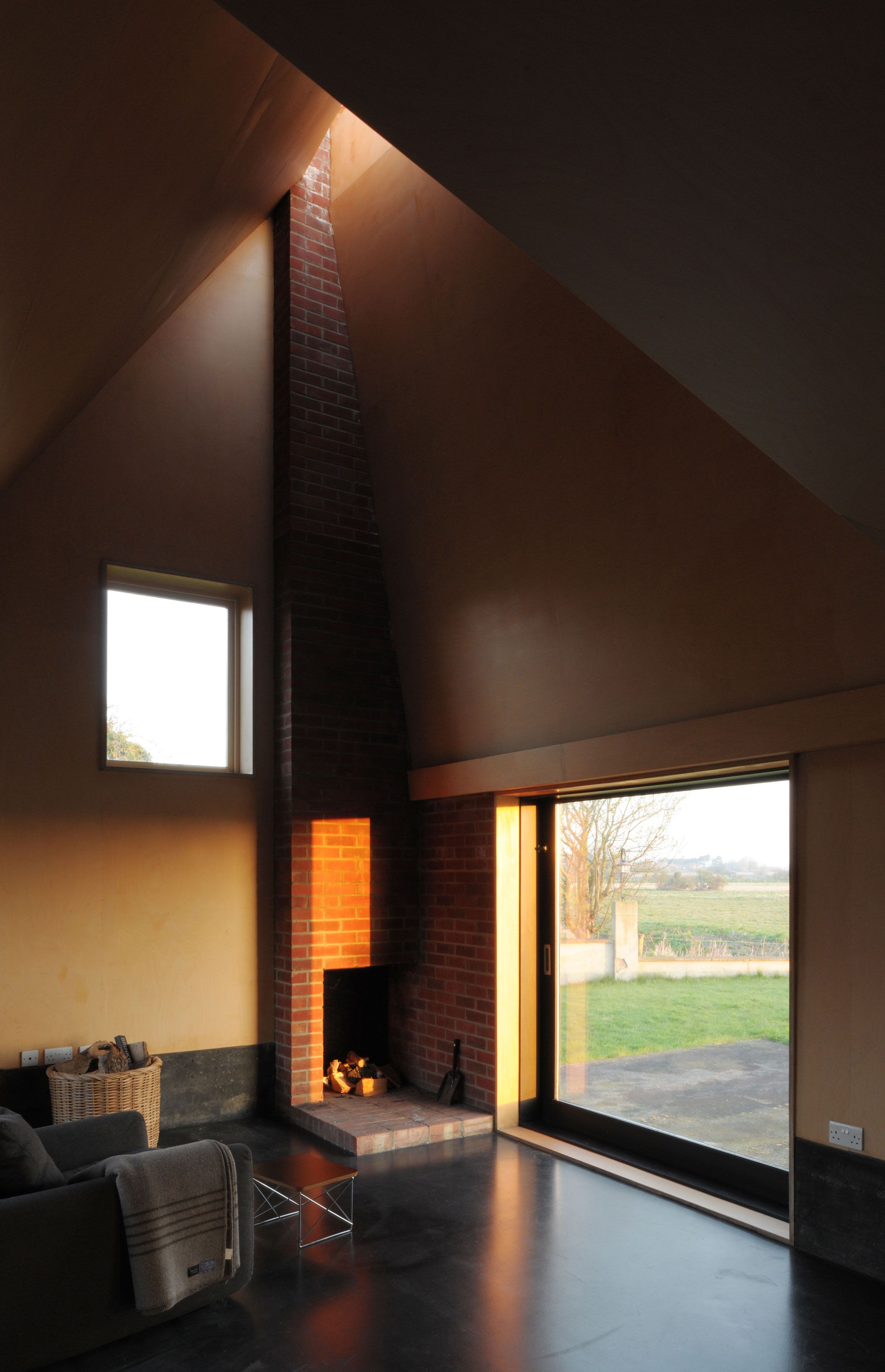 Image may contain: Fireplace, Indoors, Couch, Furniture, Architecture, Building, House, Housing, Loft, and Room