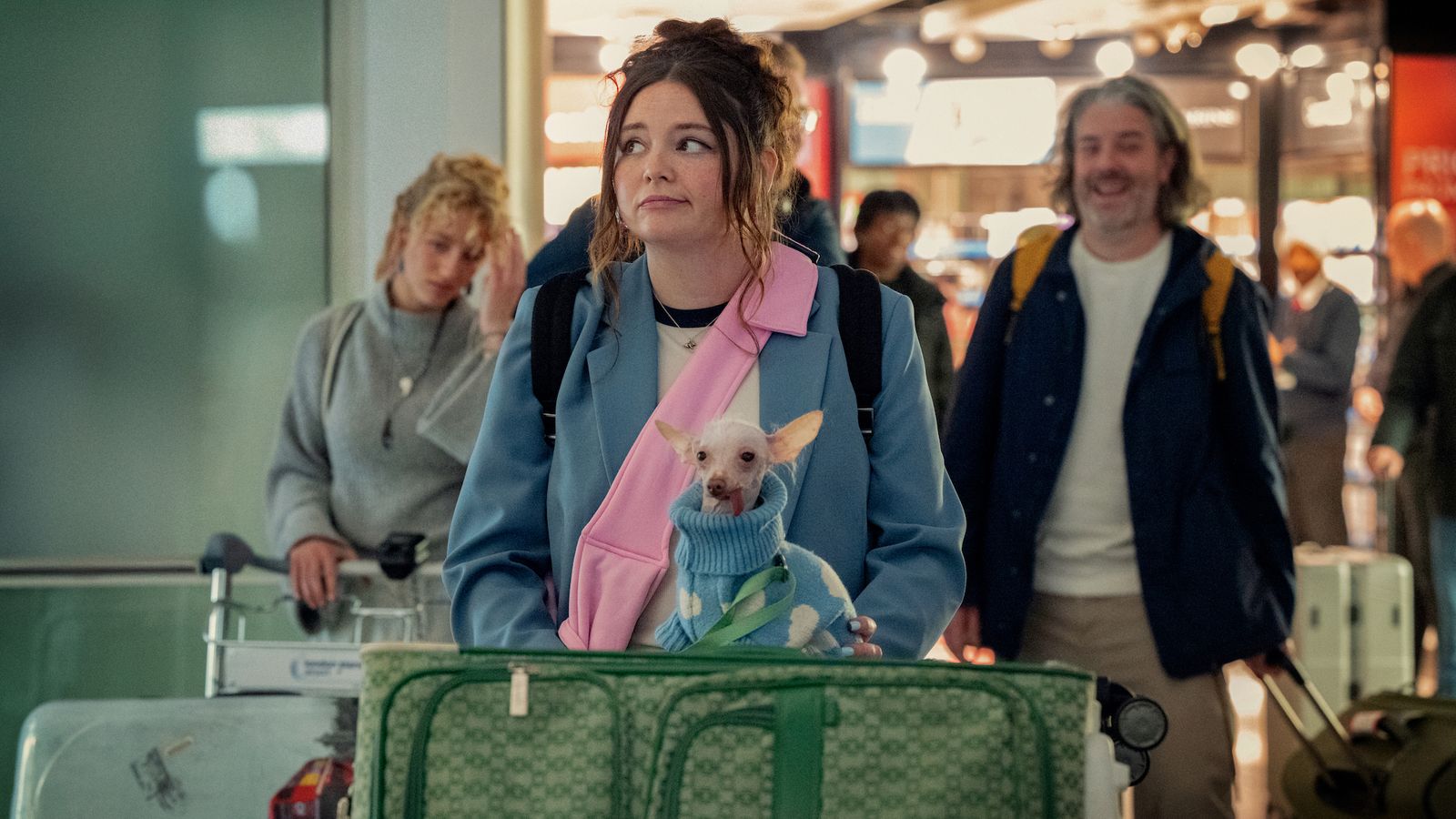 Image may contain Lance Bangs Clothing Coat Adult Person Jacket Airport Accessories Jewelry Necklace and People