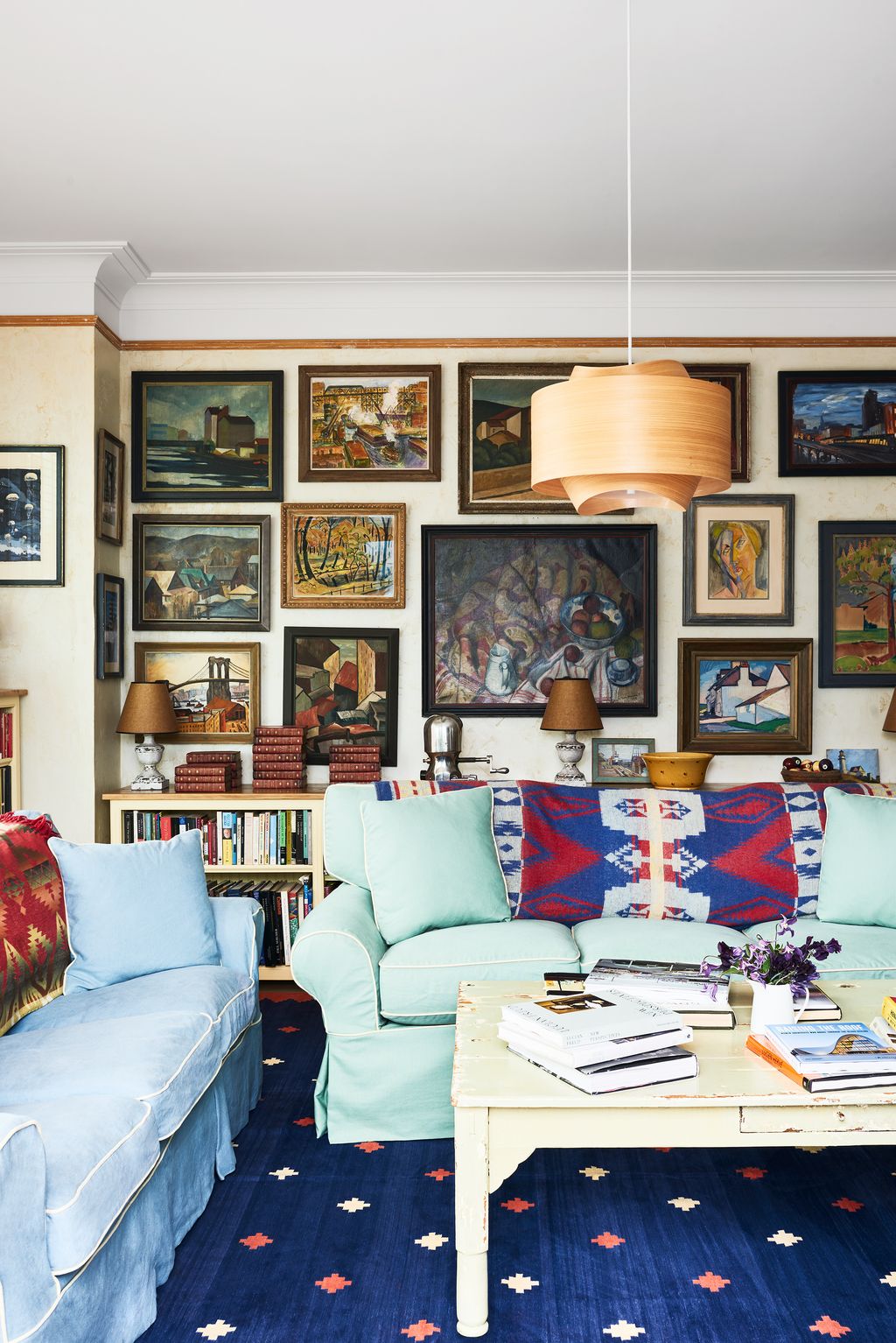 Image may contain Home Decor Lamp Couch Furniture Art Painting Architecture Building Indoors Living Room and Room