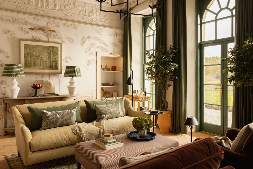 Image may contain Home Decor Lamp Plant Couch Furniture Art Painting Cushion Table Rug Architecture and Building