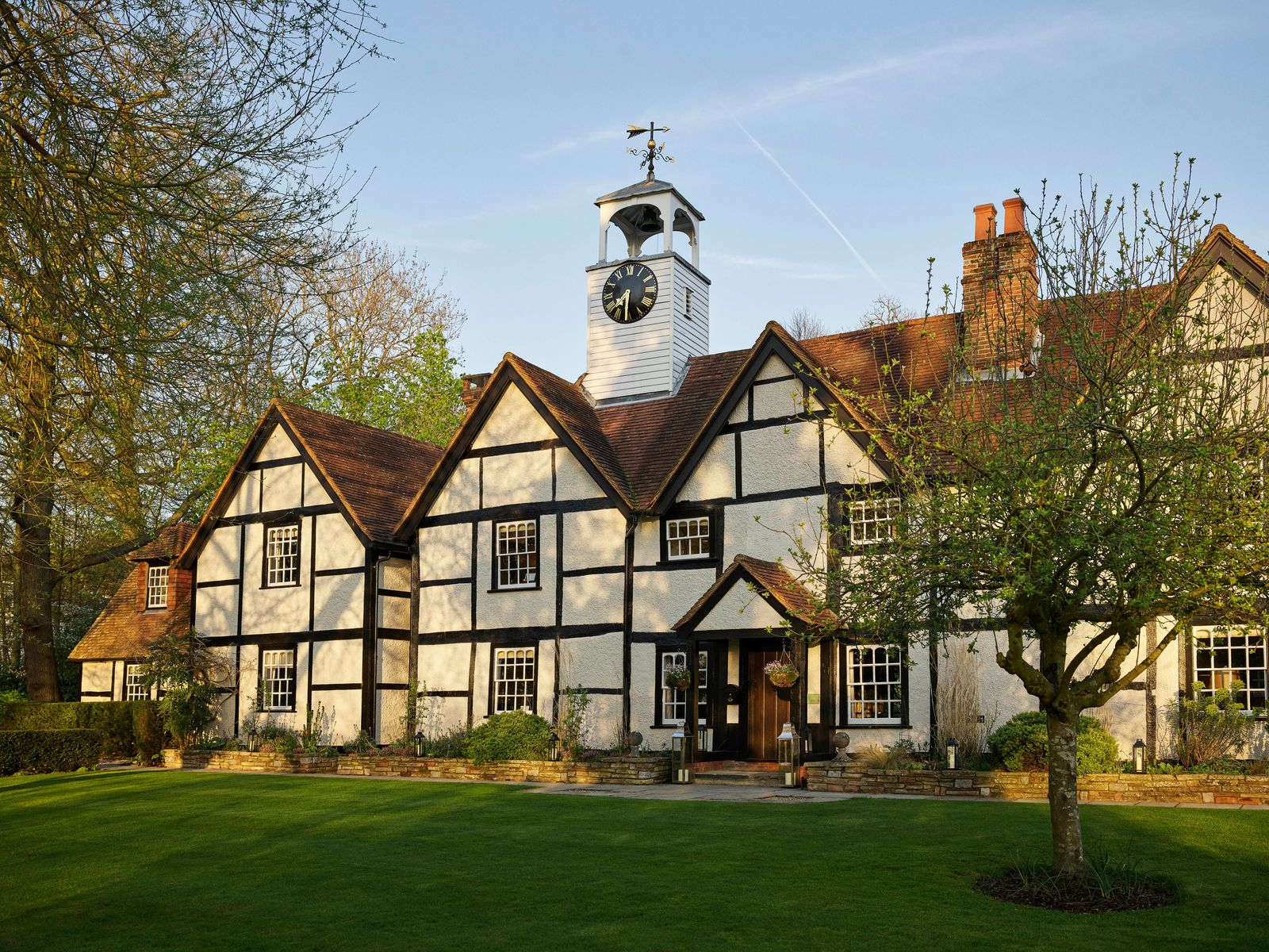 Image may contain Architecture Building Housing House Manor Clock Tower Tower Plant and Grass