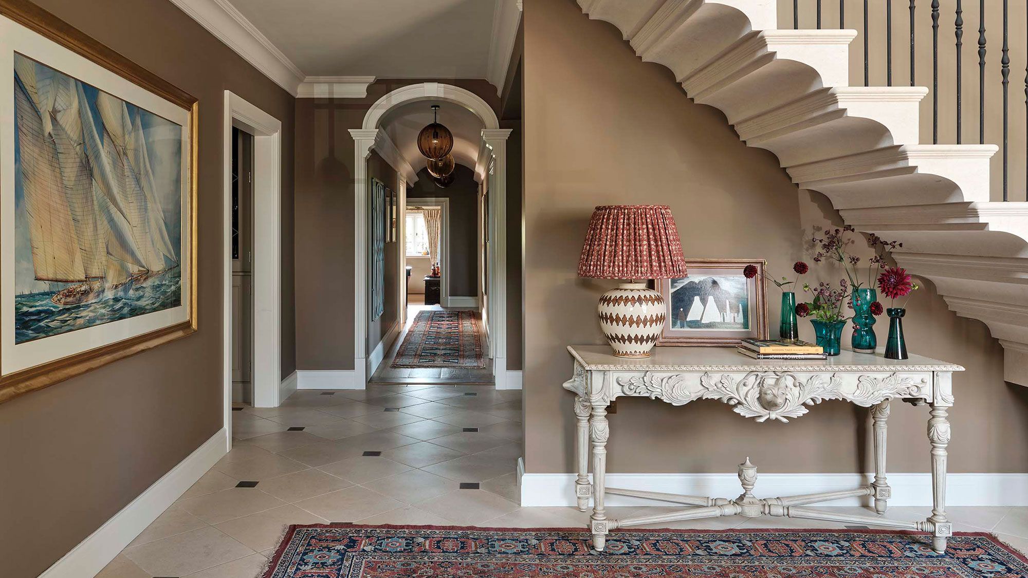 Image may contain: Architecture, Building, Foyer, Indoors, Lamp, Desk, Furniture, Table, Home Decor, Rug, Art, and Painting