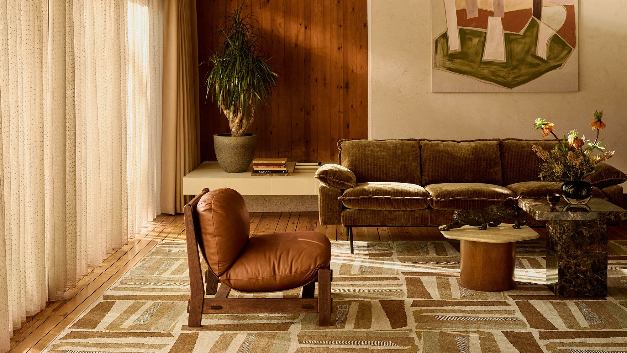 Image may contain: Indoors, Interior Design, Floor, Plant, Home Decor, Couch, Furniture, Chair, Flooring, and Rug