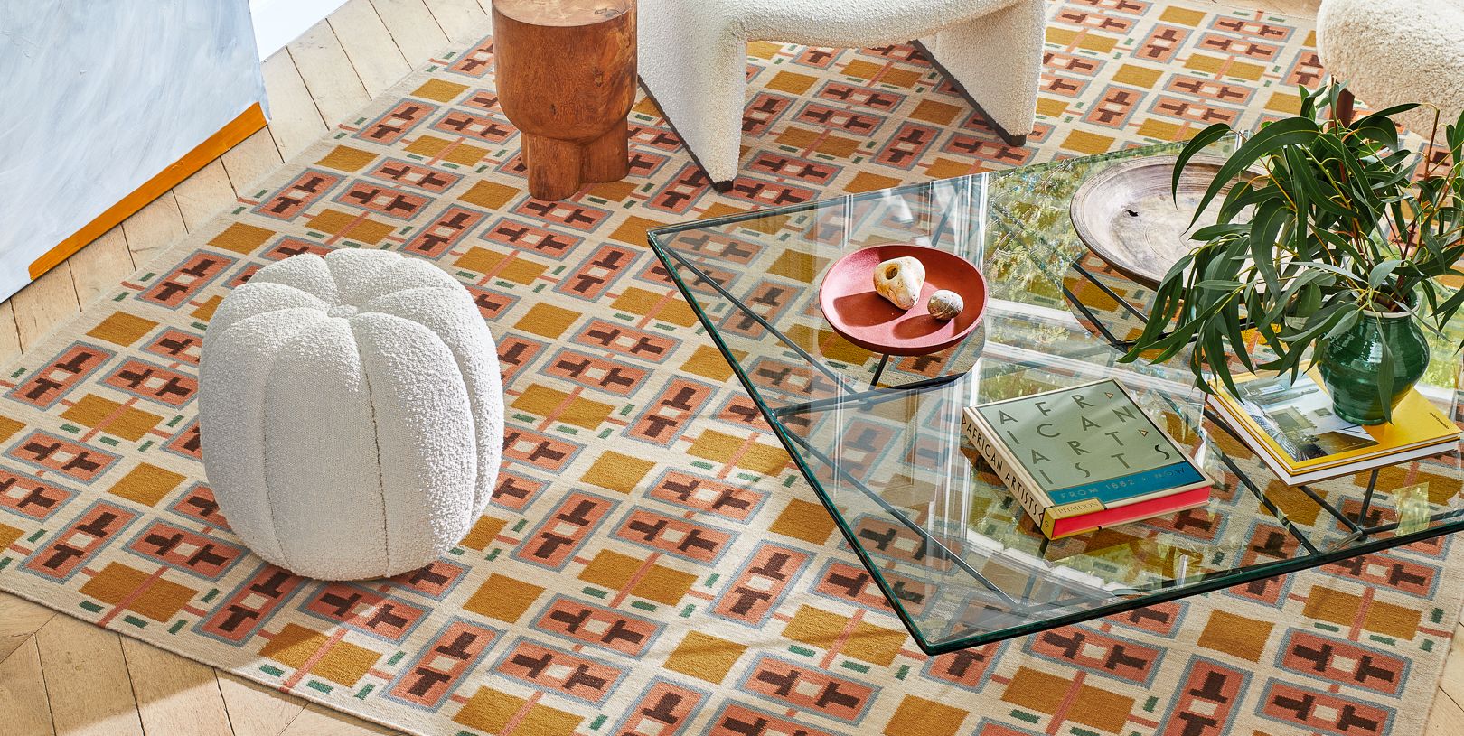 Image may contain: Furniture, Table, Home Decor, Rug, Coffee Table, Book, Publication, Tabletop, Plate, Plant, and Animal