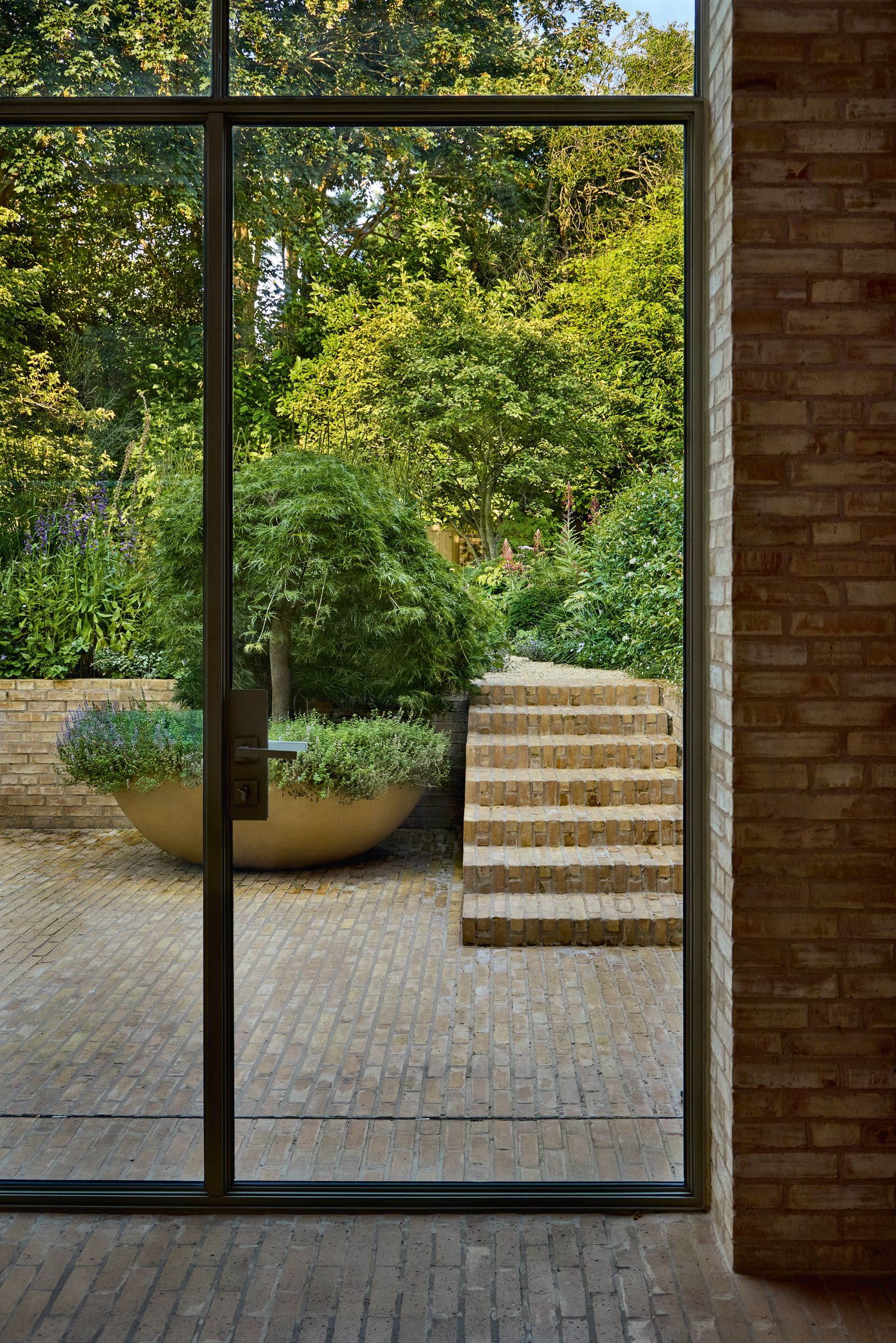 Image may contain Indoors Interior Design Door Plant Potted Plant French Window Window Herbal Herbs Floor and Jar