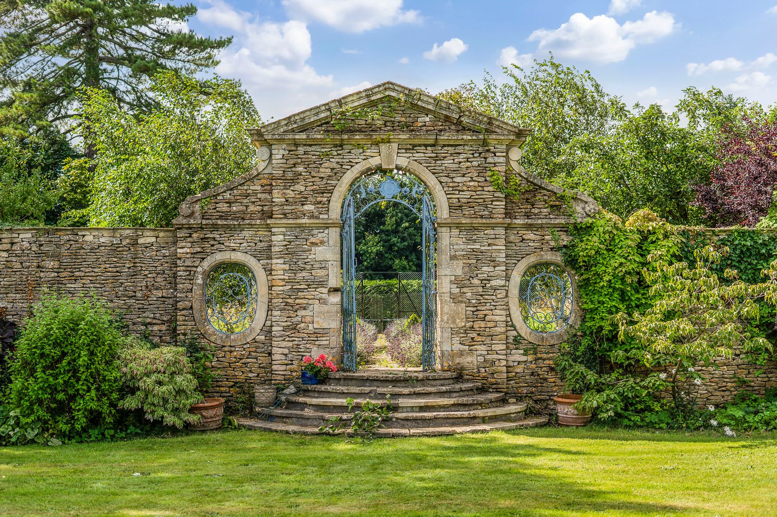 Image may contain Architecture Building Cottage House Housing Arch Grass Plant Gothic Arch Garden and Nature