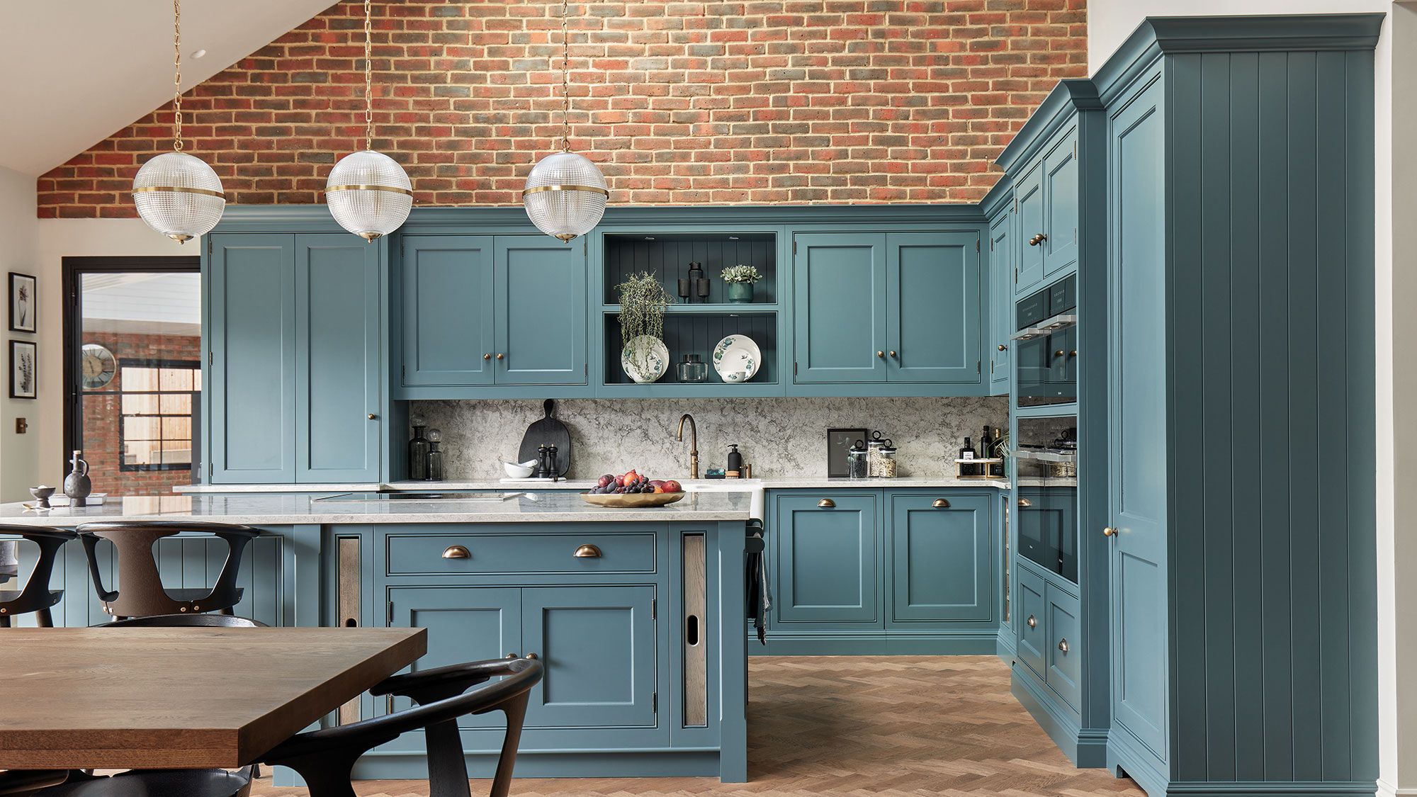 Image may contain: Indoors, Interior Design, Kitchen, Plant, Lamp, Plate, Chair, Furniture, and Kitchen Island