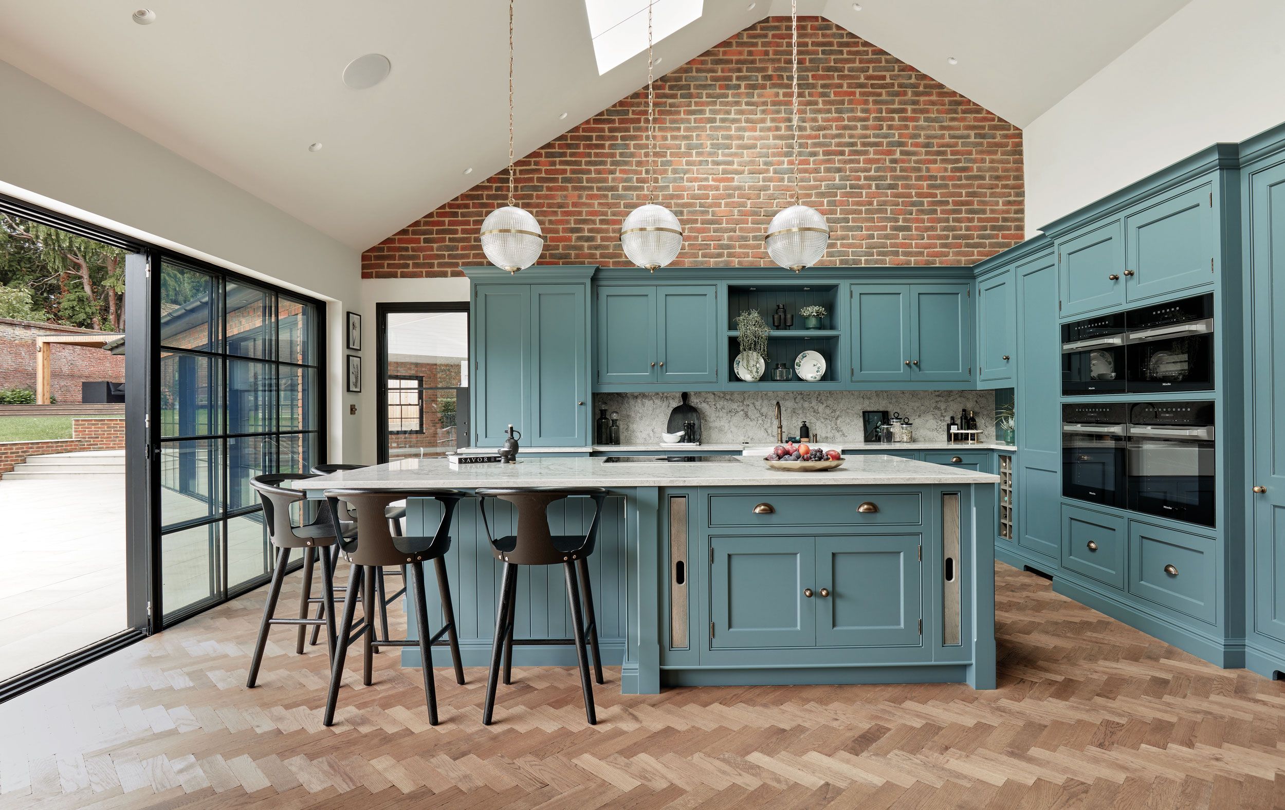 Image may contain: Indoors, Interior Design, Kitchen, Kitchen Island, Lamp, Chair, and Furniture