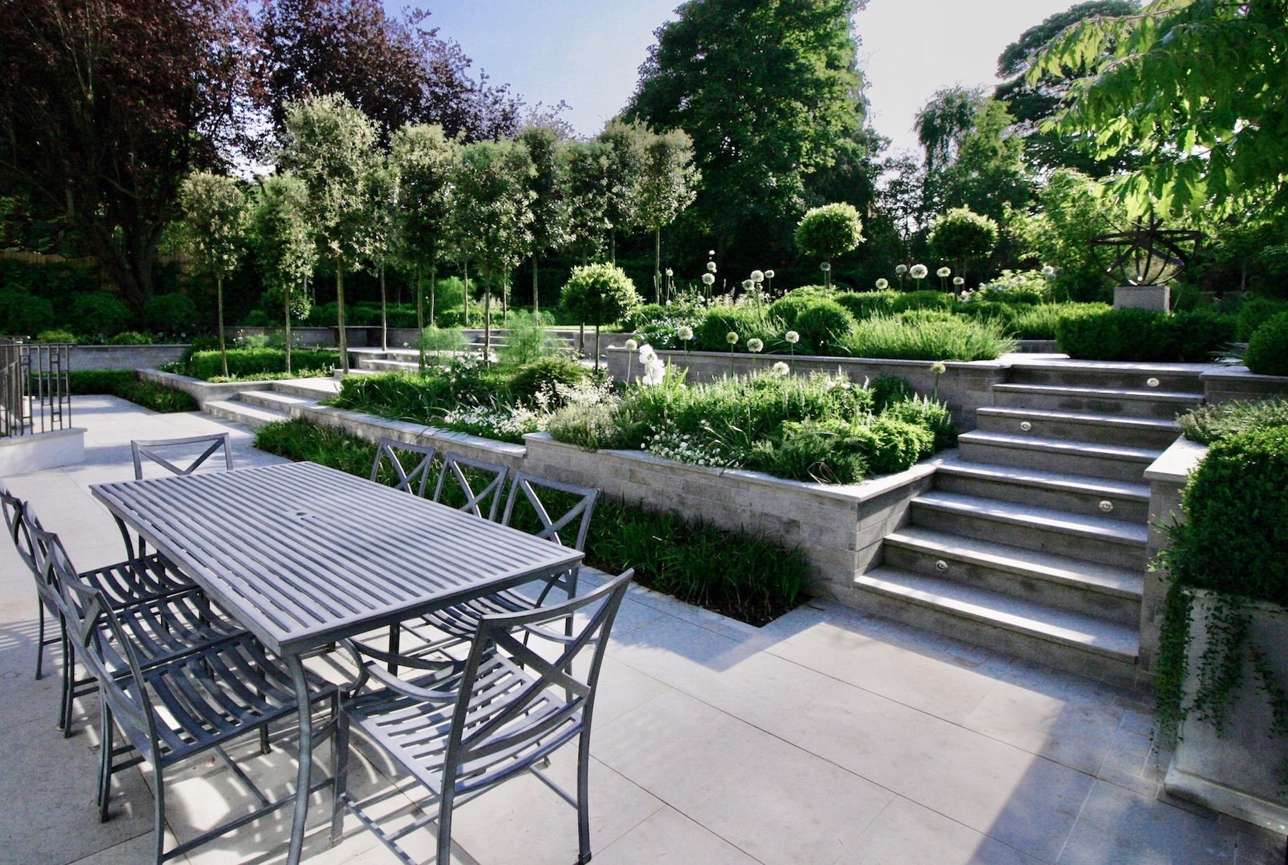 Image may contain: Garden, Nature, Outdoors, Grass, Park, Plant, Backyard, Yard, Scenery, Chair, Furniture, Desk, and Table