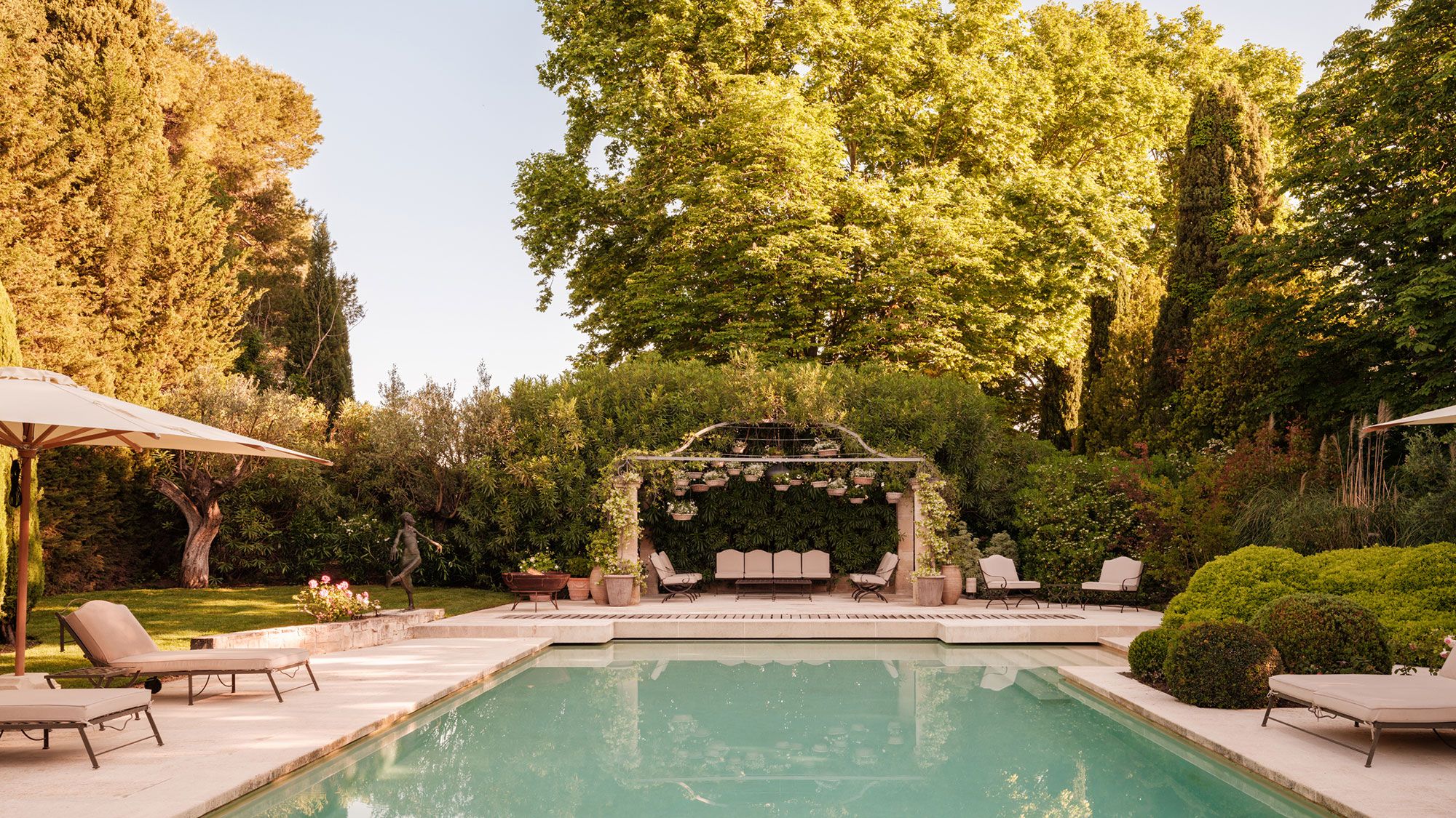 Image may contain: Backyard, Nature, Outdoors, Yard, Chair, Furniture, Garden, Pool, Water, Person, Scenery, Plant, and Grass