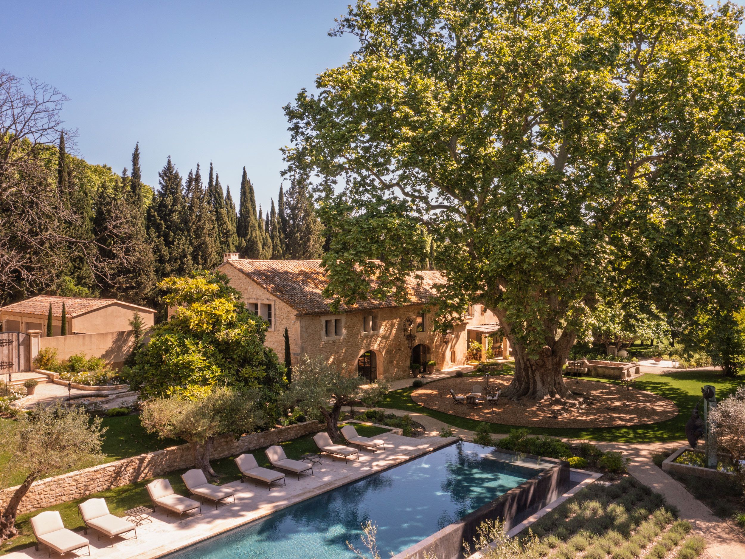 Image may contain: Architecture, Building, House, Housing, Villa, Pool, Water, Chair, Furniture, Swimming Pool, and Outdoors