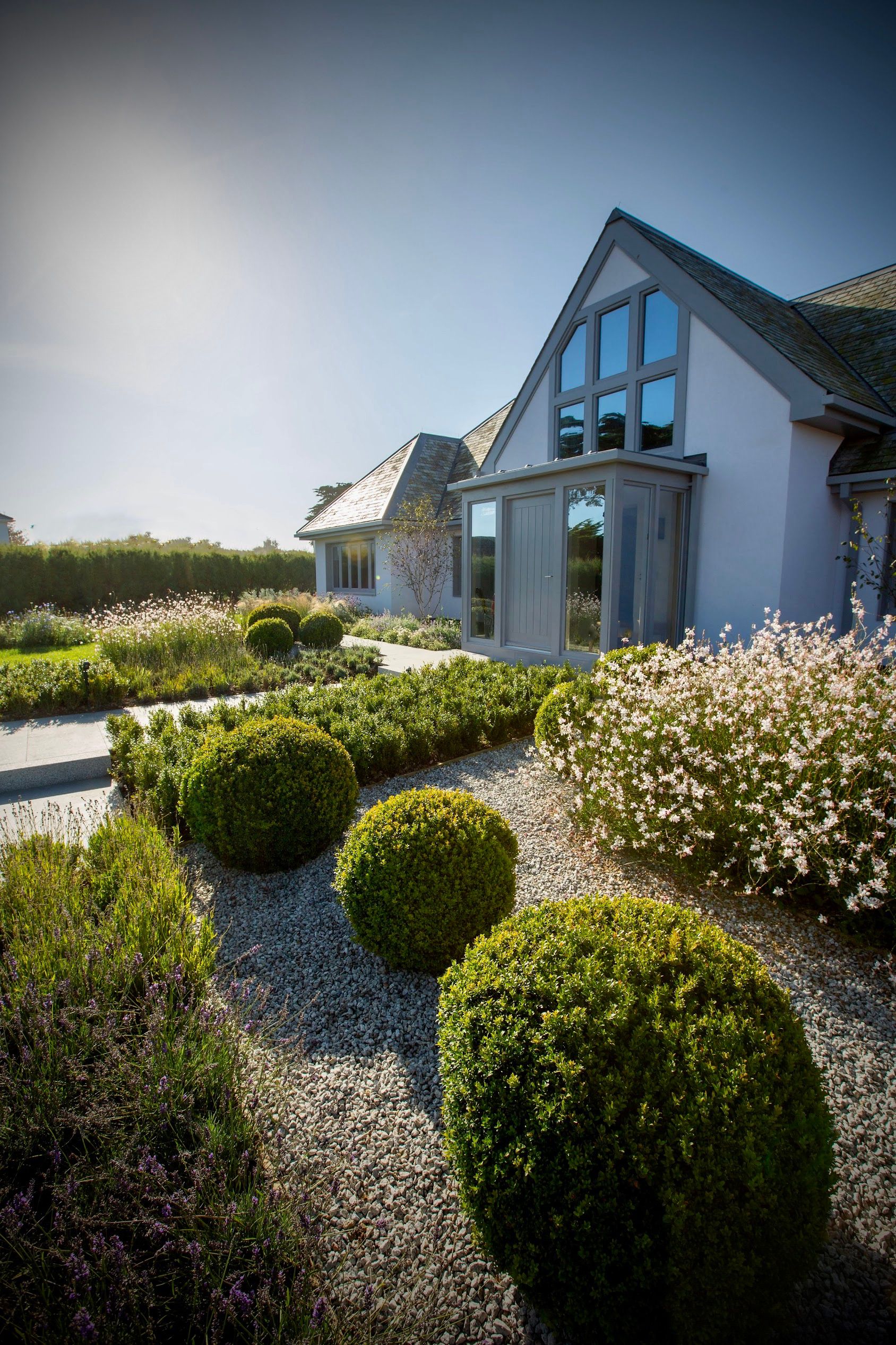 Image may contain: Grass, Plant, Architecture, Building, Cottage, House, Housing, Fence, Hedge, Vegetation, and Garden