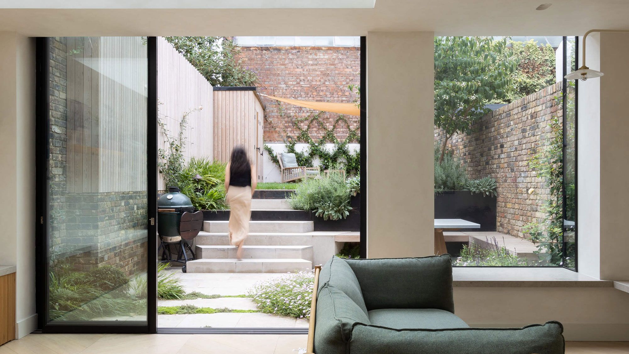 Image may contain: Door, Person, Couch, Furniture, Window, Indoors, and Interior Design