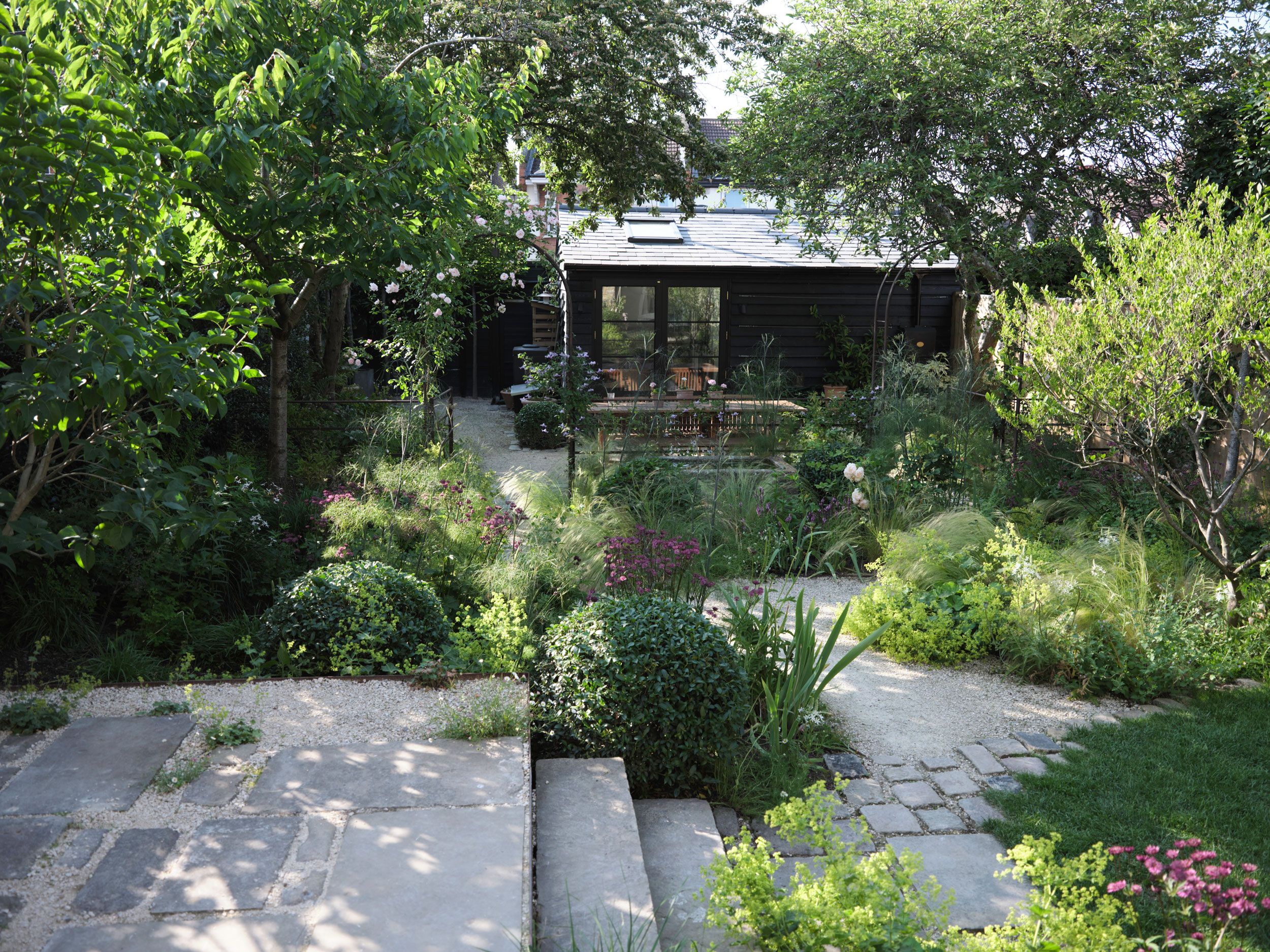 Image may contain: Architecture, Building, Cottage, House, Housing, Garden, Nature, Outdoors, Backyard, Yard, and Plant