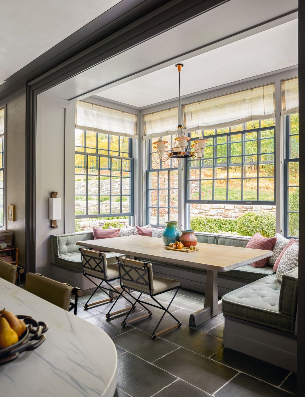 Image may contain Lamp Window French Window Desk Furniture Table Chair Couch Bay Window Bread Food and Fruit