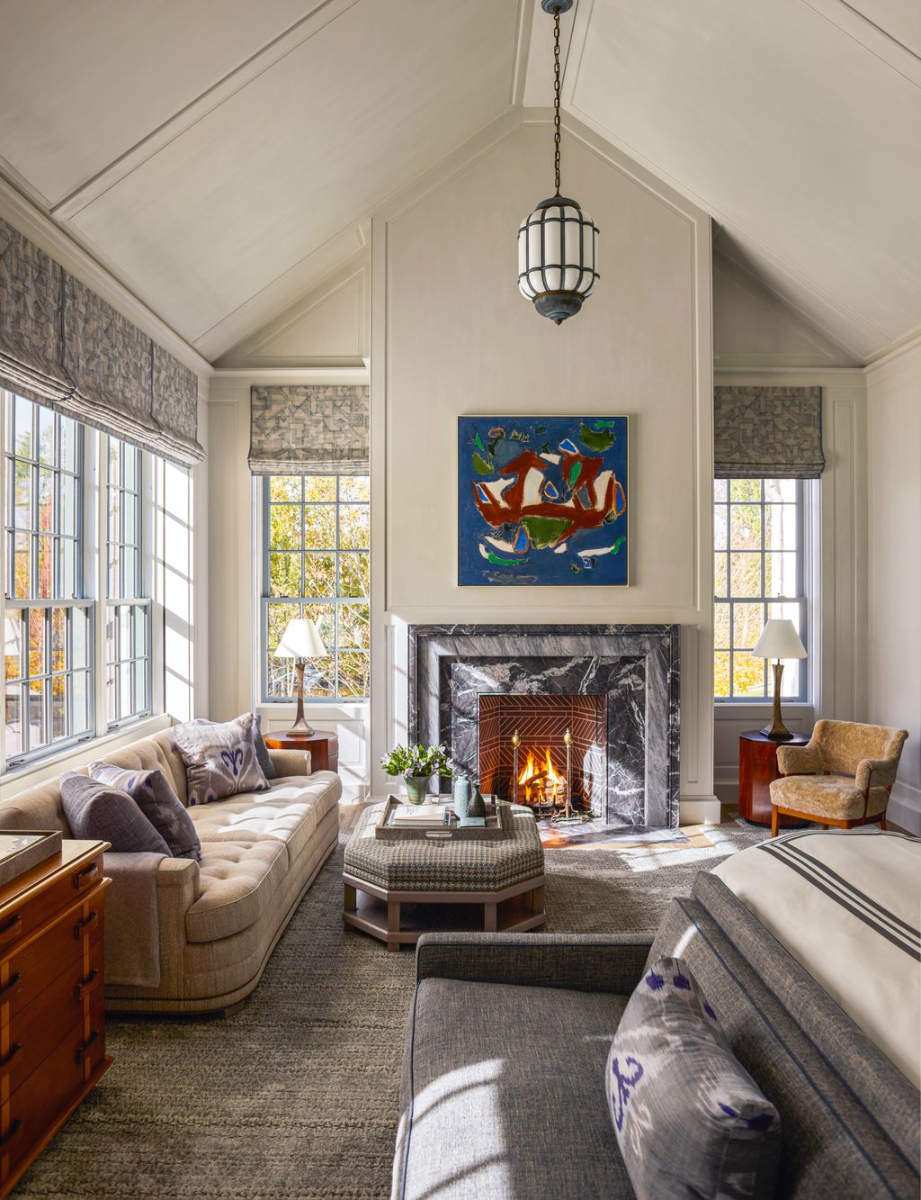 Image may contain Home Decor Lamp Couch Furniture Fireplace Indoors Chair and Table