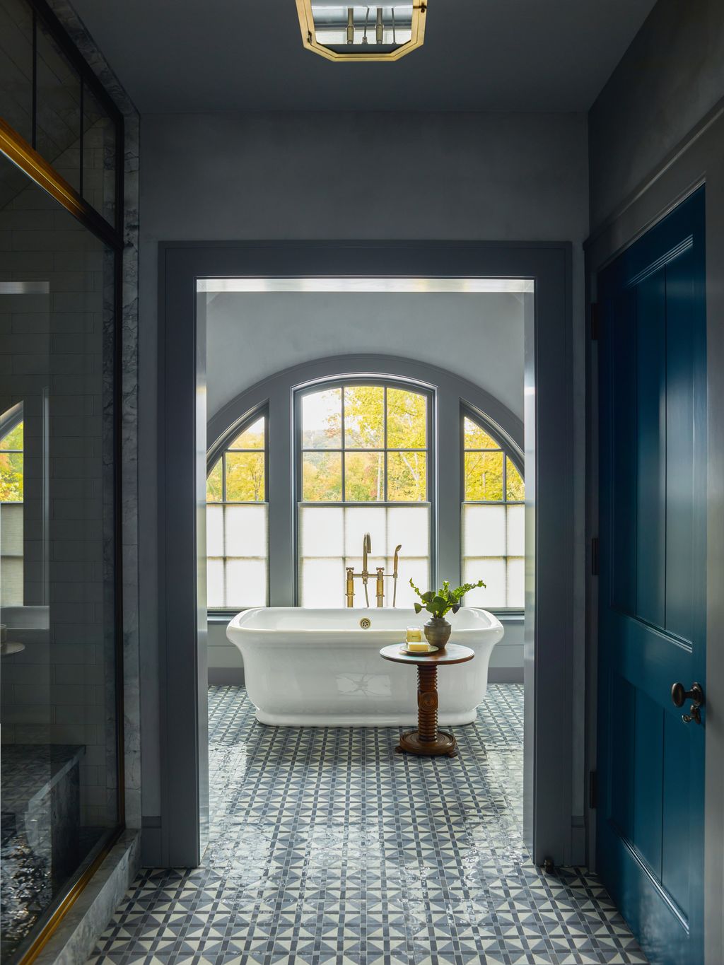 Image may contain Floor Desk Furniture Table Indoors Interior Design Plant Bathing Bathtub Person and Tub