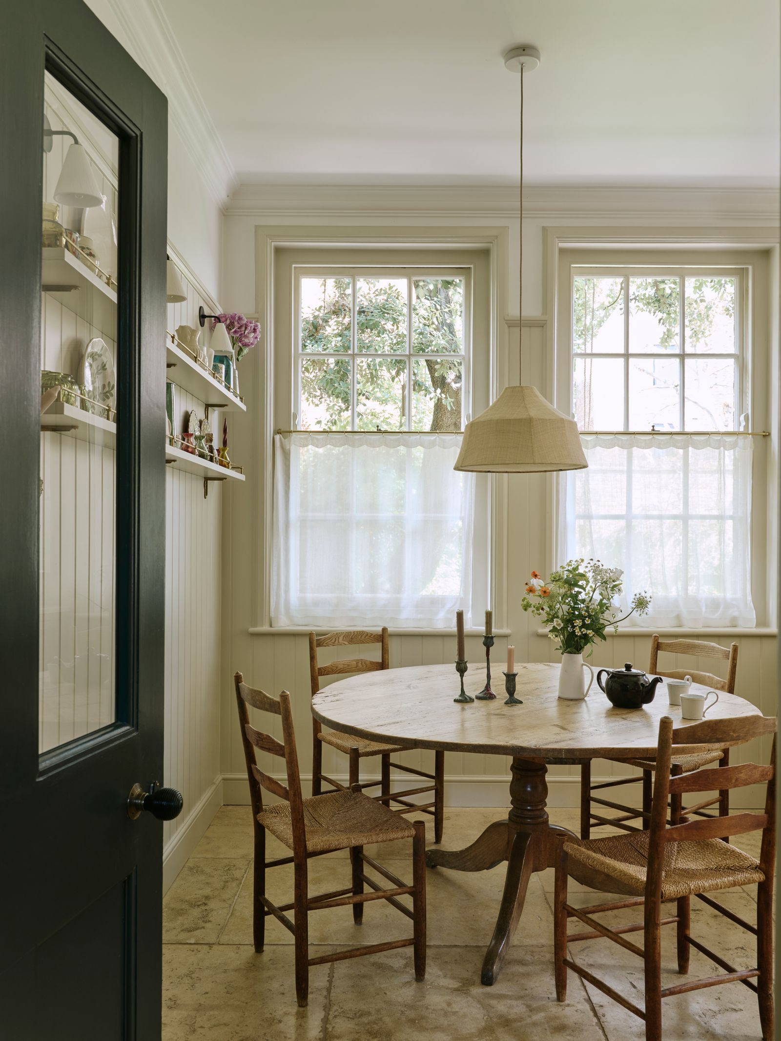 Image may contain Architecture Building Dining Room Dining Table Furniture Indoors Room Table Lamp Chair and Desk