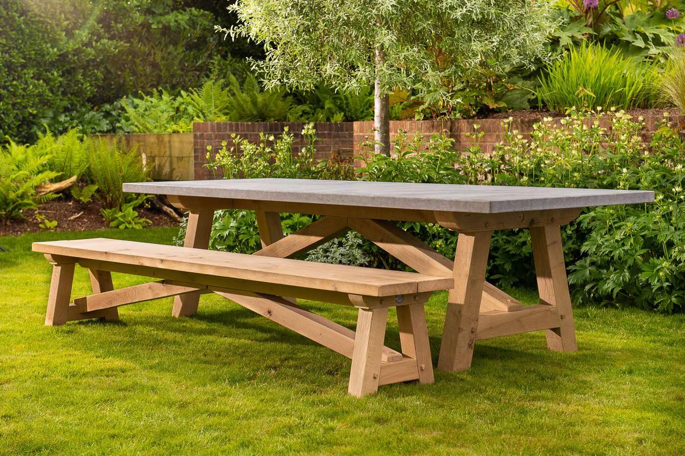 Image may contain: Wood, Bench, Furniture, Desk, Table, Hardwood, Stained Wood, Grass, and Plant