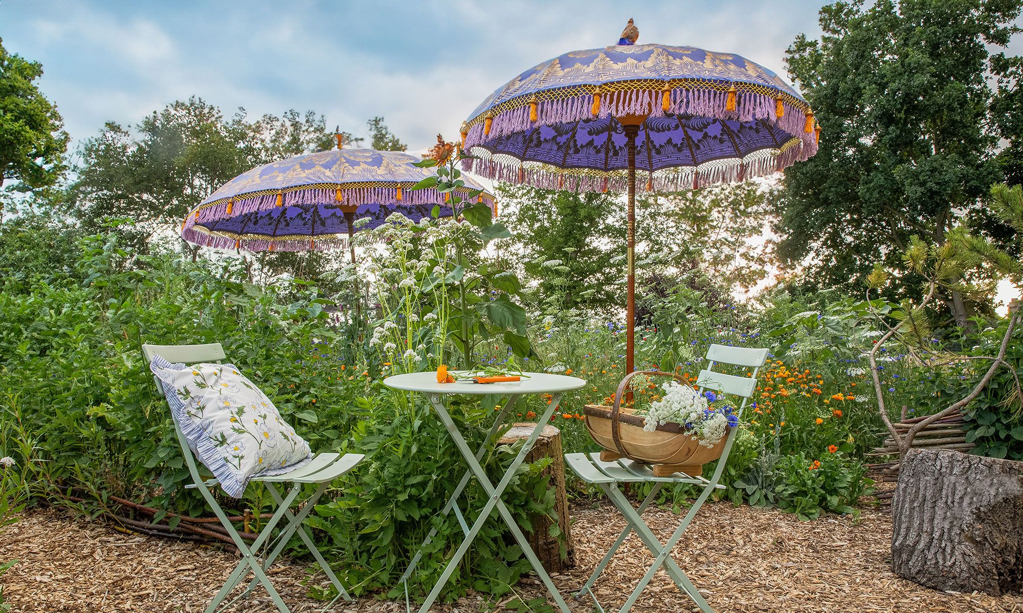 Image may contain: Chair, Furniture, Desk, Table, Architecture, Building, House, Housing, Patio, Patio Umbrella, and Grass