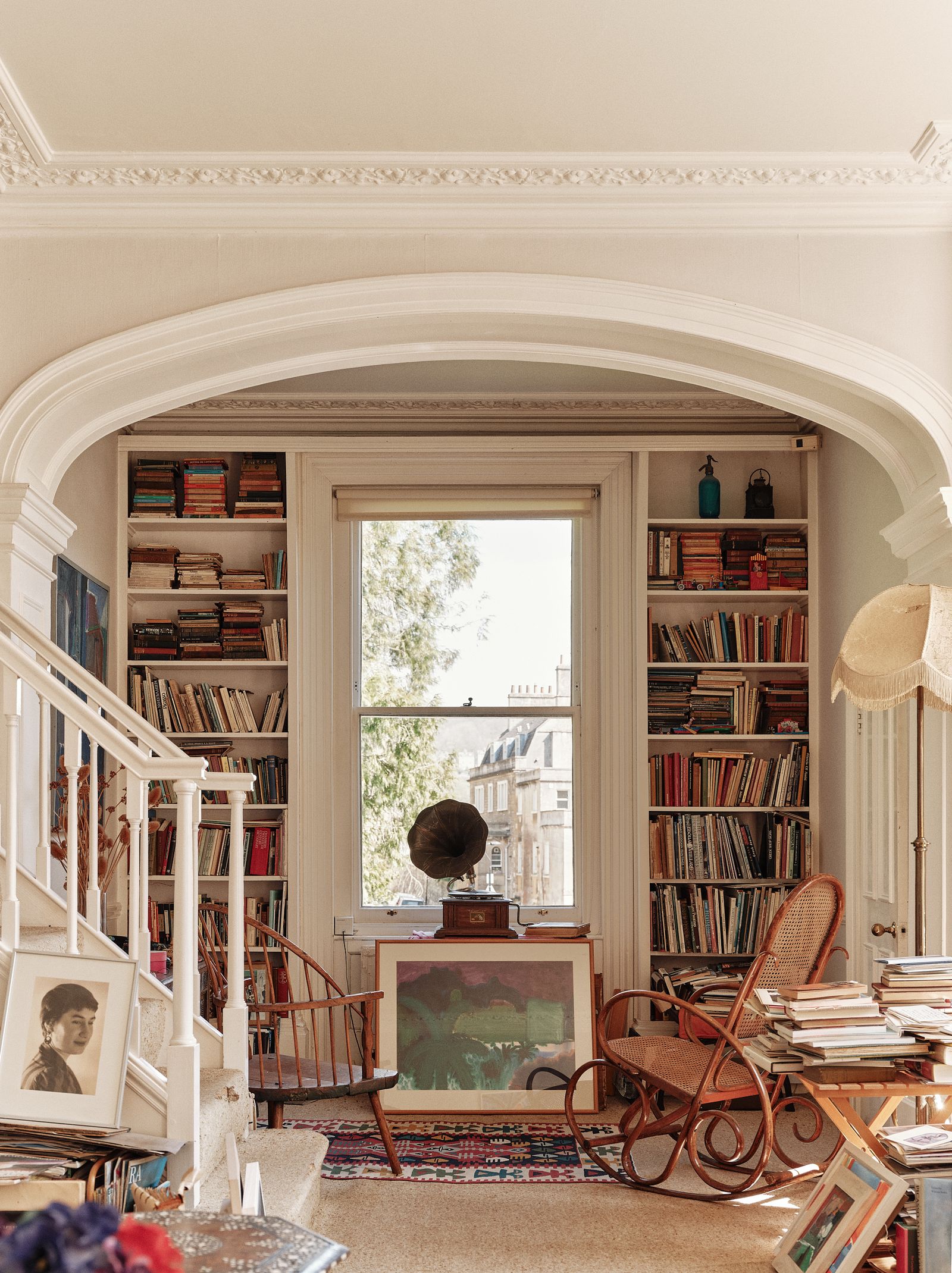 Image may contain Chair Furniture Person Accessories Bag Handbag Art Painting Lamp Bookcase and Architecture