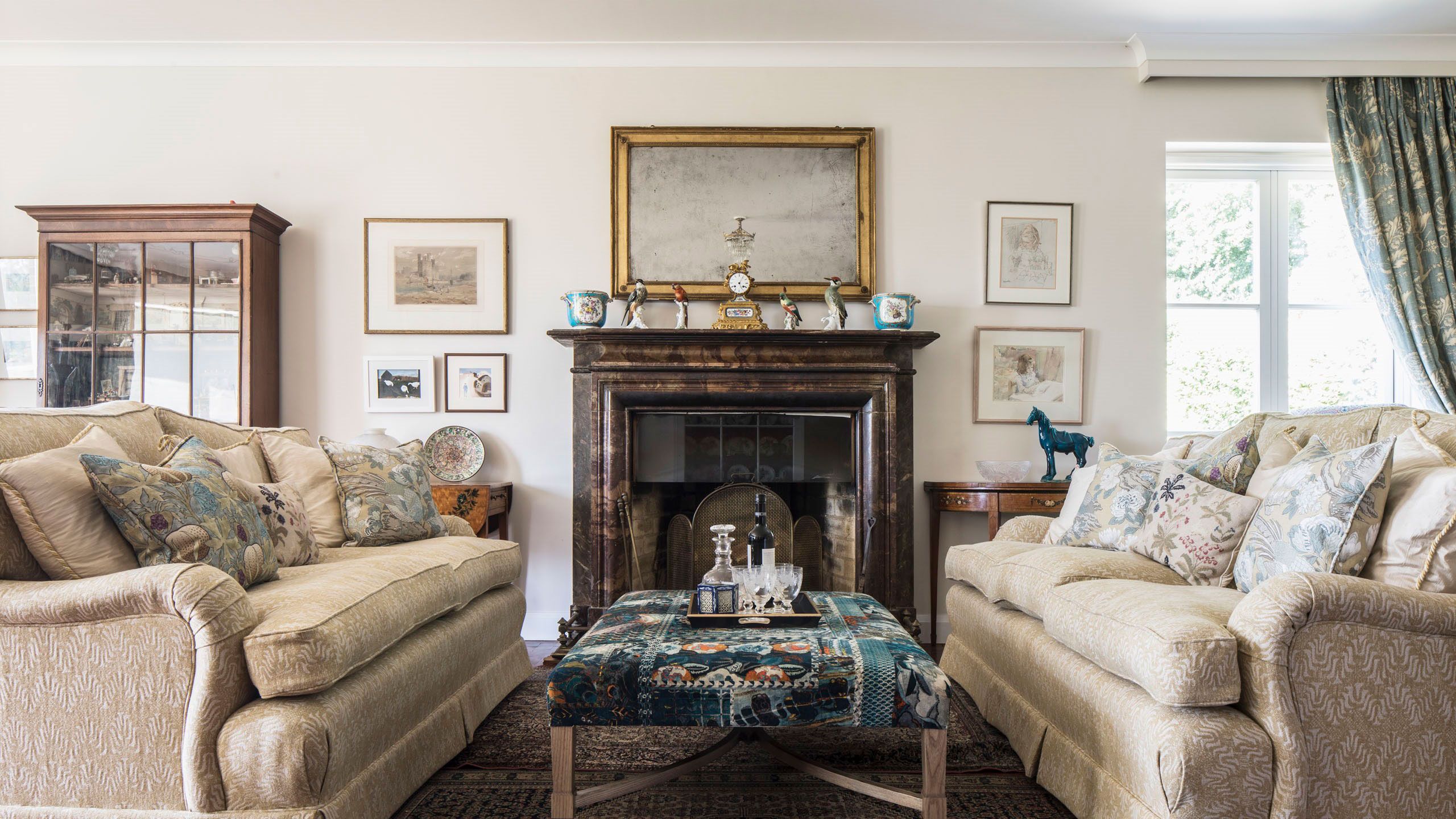 Image may contain: Home Decor, Couch, Furniture, Table, Art, Painting, Rug, Architecture, Building, Indoors, and Living Room