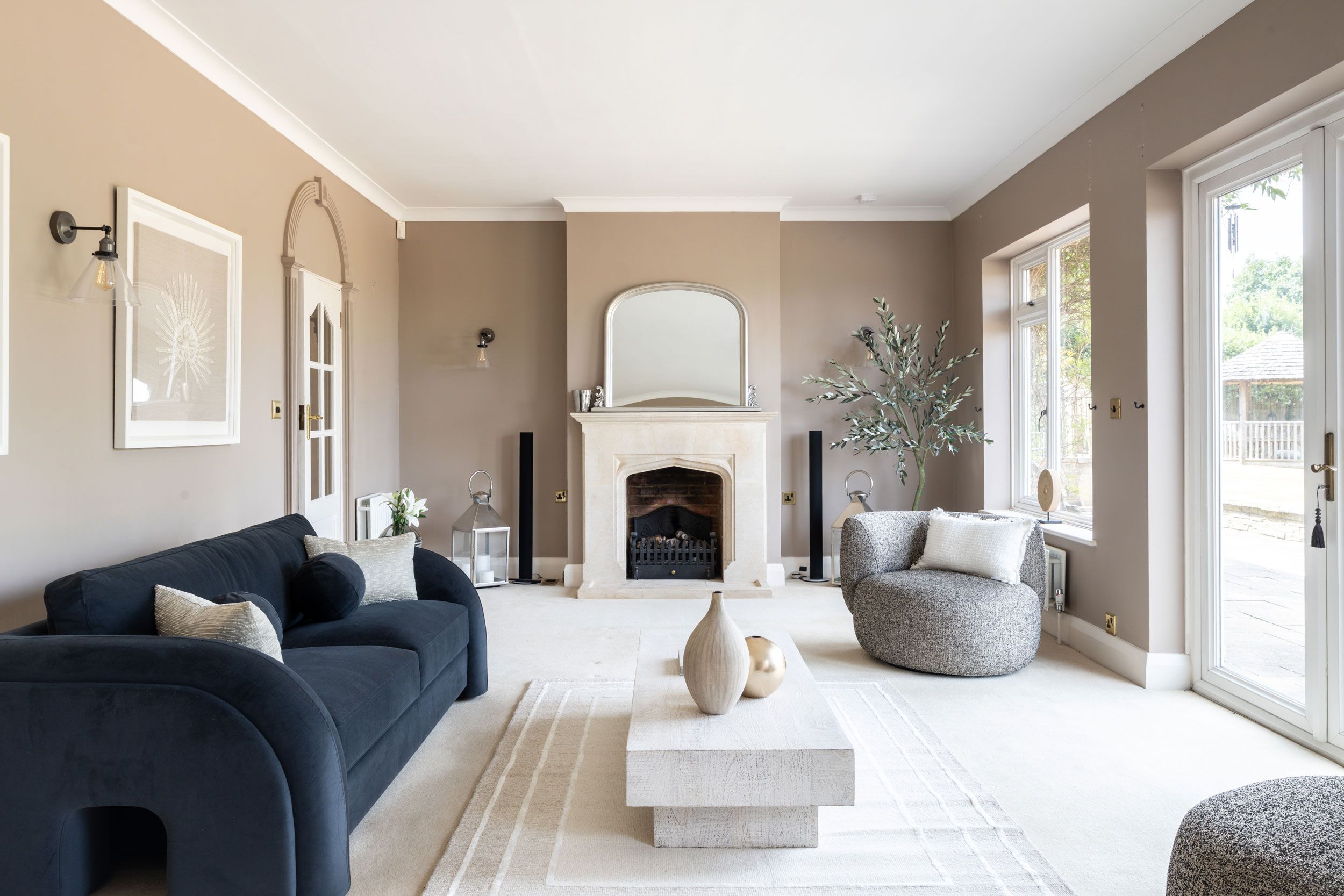 Image may contain: Home Decor, Couch, Furniture, Architecture, Building, Indoors, Living Room, Room, Fireplace, Lamp, and Rug