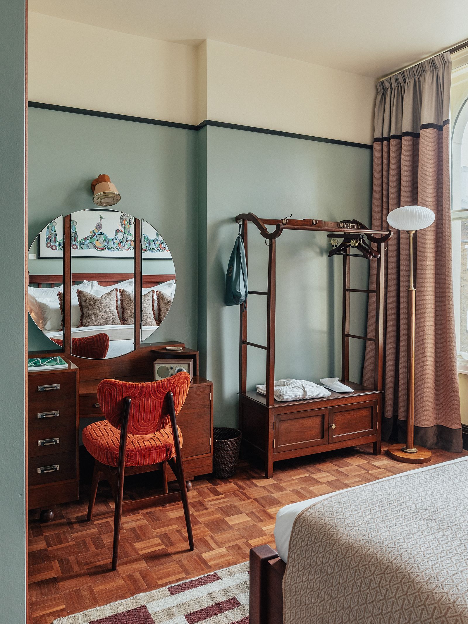 Image may contain Chair Furniture Bed Bedroom Indoors Room Home Decor Rug Accessories Bag Handbag and Book