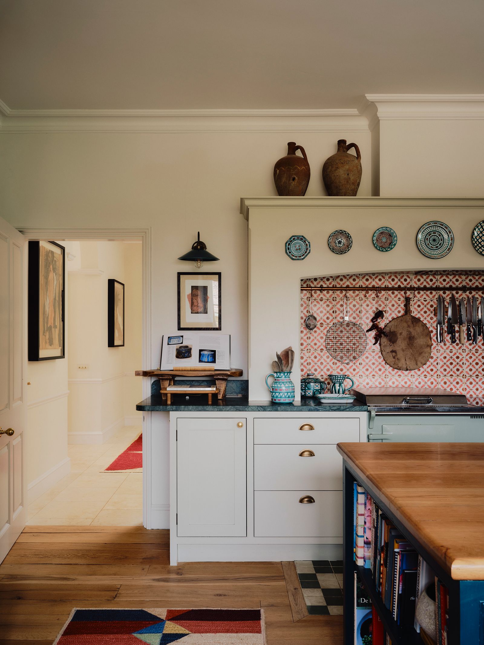 Image may contain Indoors Interior Design Home Decor Rug Art Painting Plate Furniture Table Wood and Kitchen