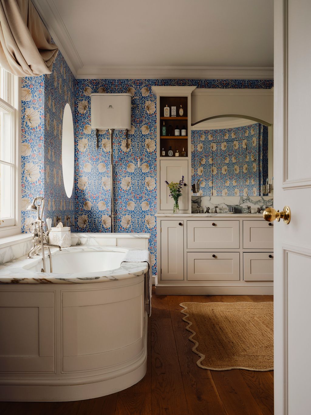 Image may contain Indoors Interior Design Home Decor Rug Bathing Bathtub Person Tub Sink and Sink Faucet