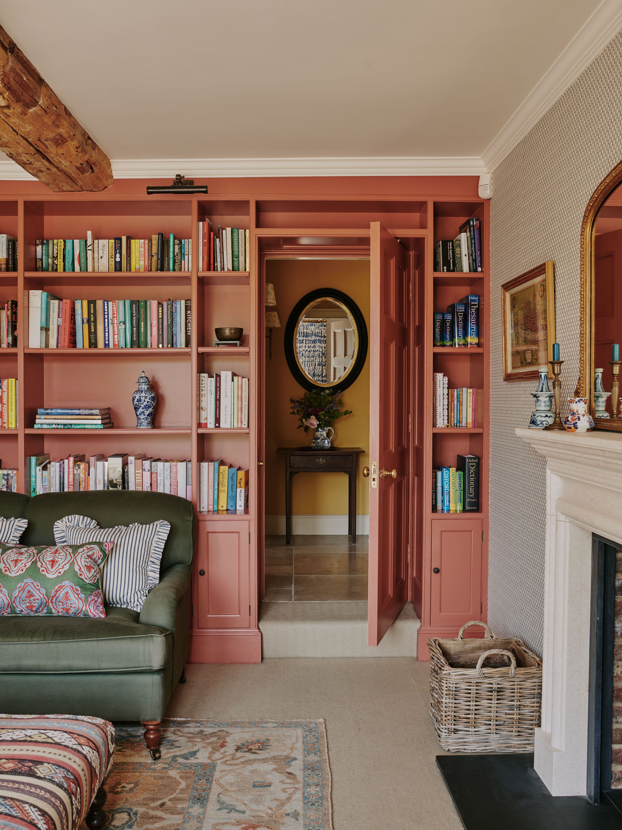 Image may contain: Furniture, Couch, Plant, Desk, Table, Art, Painting, Bookcase, Candle, Architecture, Building, and Indoors