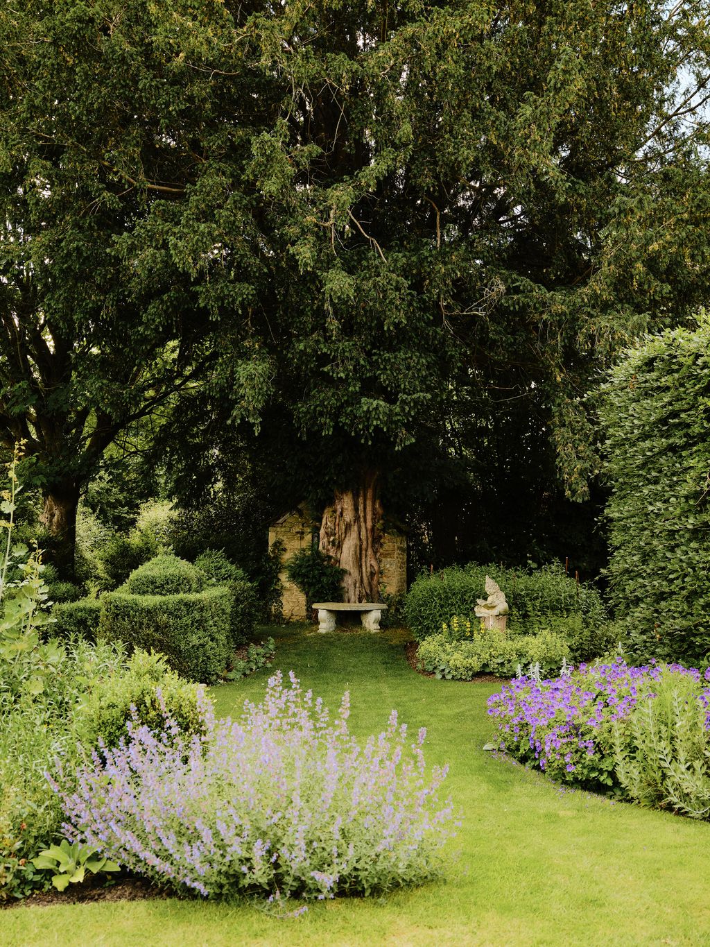 Image may contain Grass Plant Garden Nature Outdoors Park Tree Vegetation Bench Furniture Land and Woodland