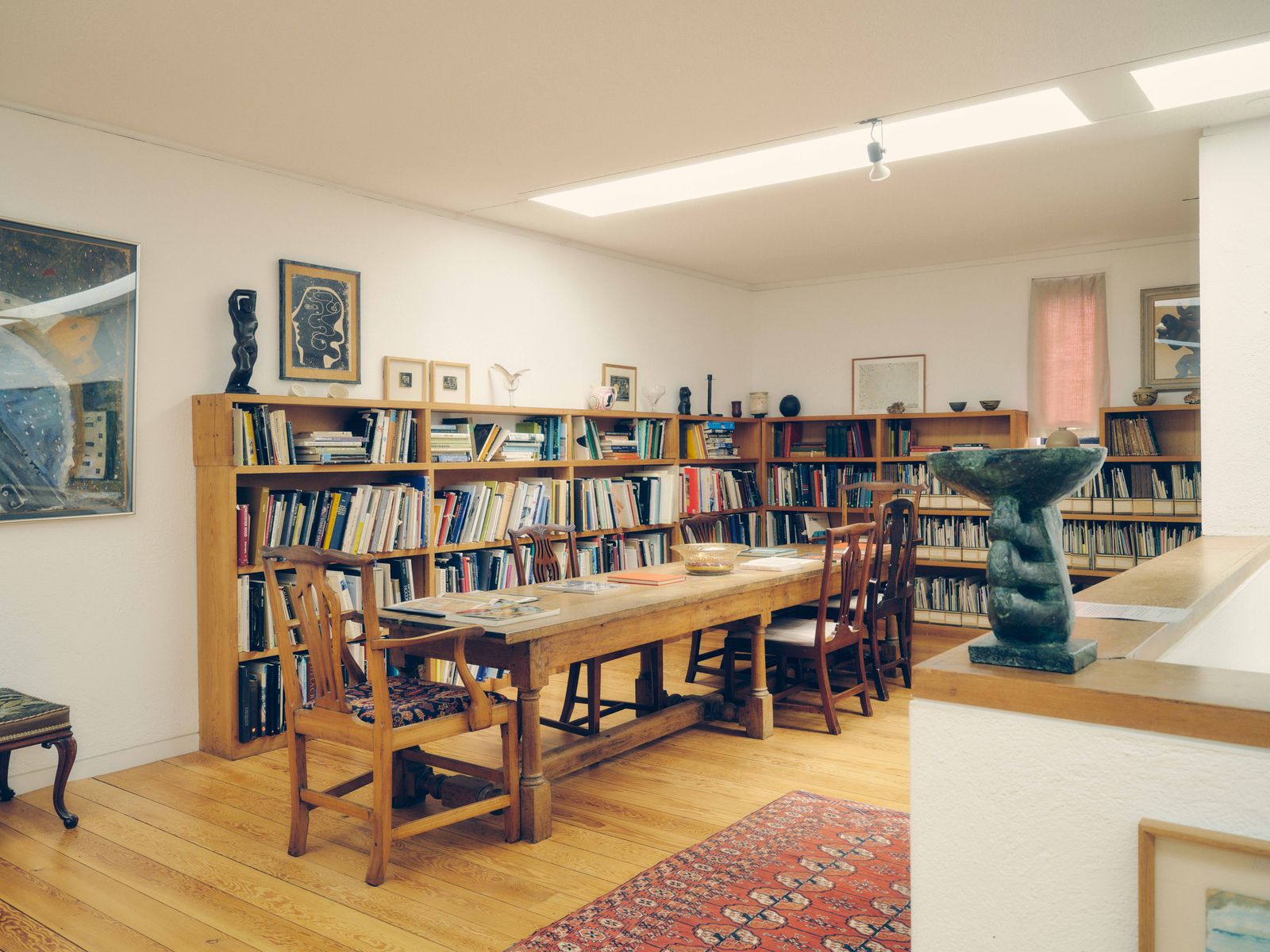 Image may contain Book Indoors Library Publication Chair Furniture Home Decor Rug Desk Table Art and Painting