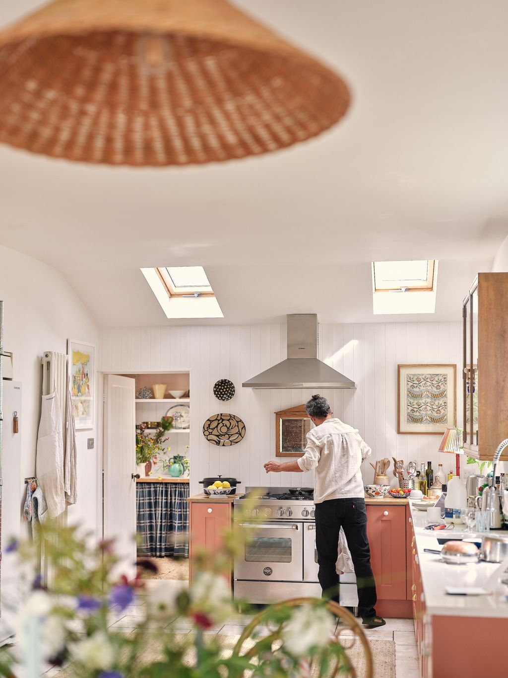 Image may contain Indoors Interior Design Adult Person Kitchen Art Painting Cup Clothing Footwear Shoe and Burger