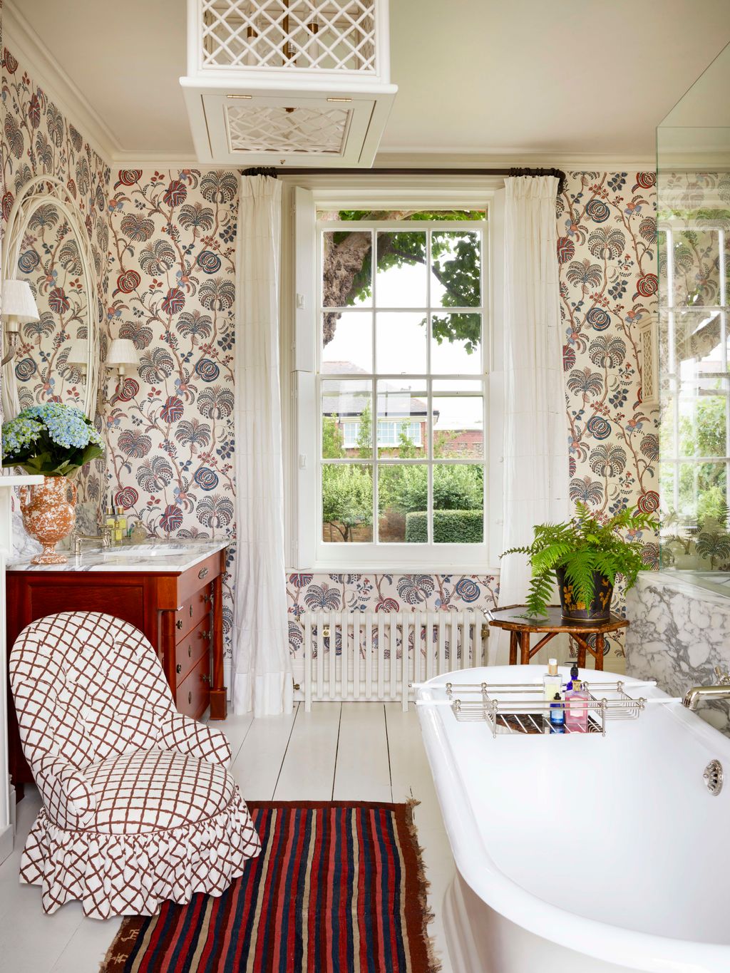 Image may contain Home Decor Rug Chair Furniture Plant Bathing Bathtub Person Tub Lamp Desk Table and Indoors