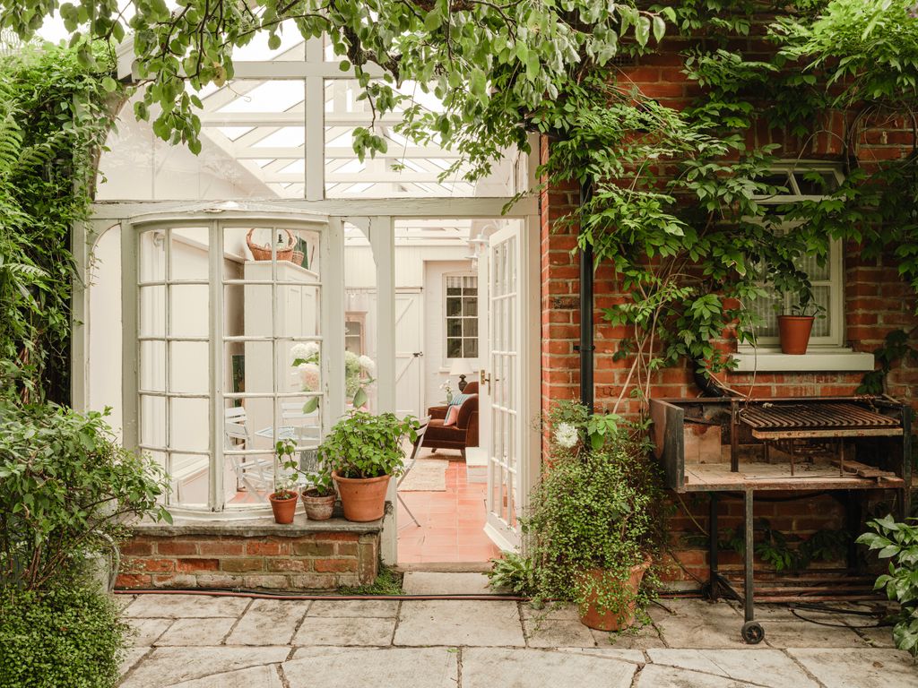 Image may contain Door Plant Architecture Building Housing Chair Furniture House French Window Window and Indoors