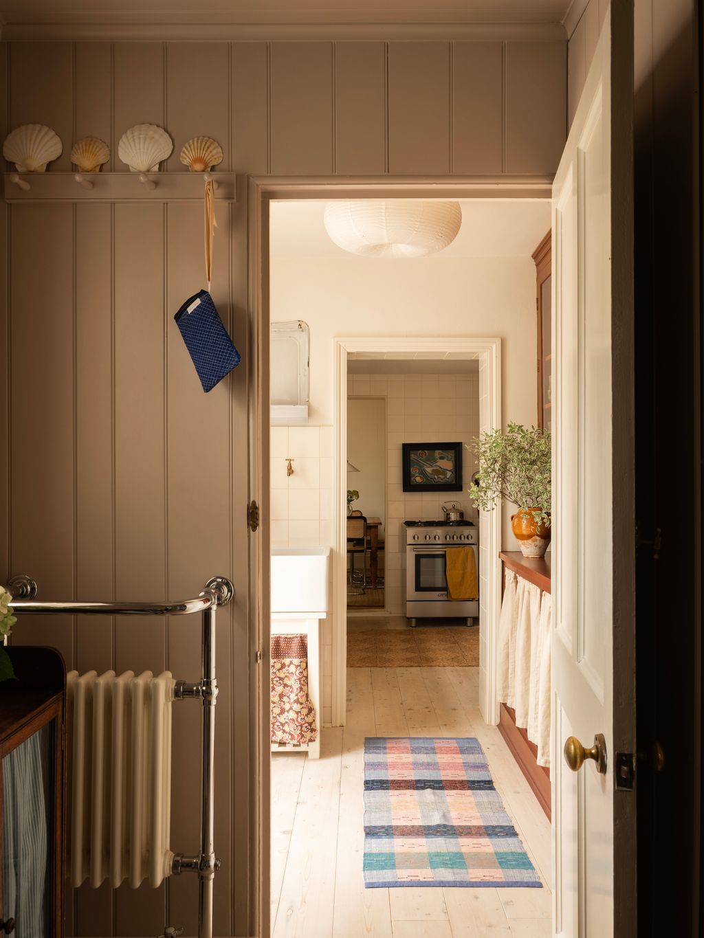 Image may contain Indoors Interior Design Lamp Home Decor Rug Plant Art Painting Cooktop Kitchen and Architecture