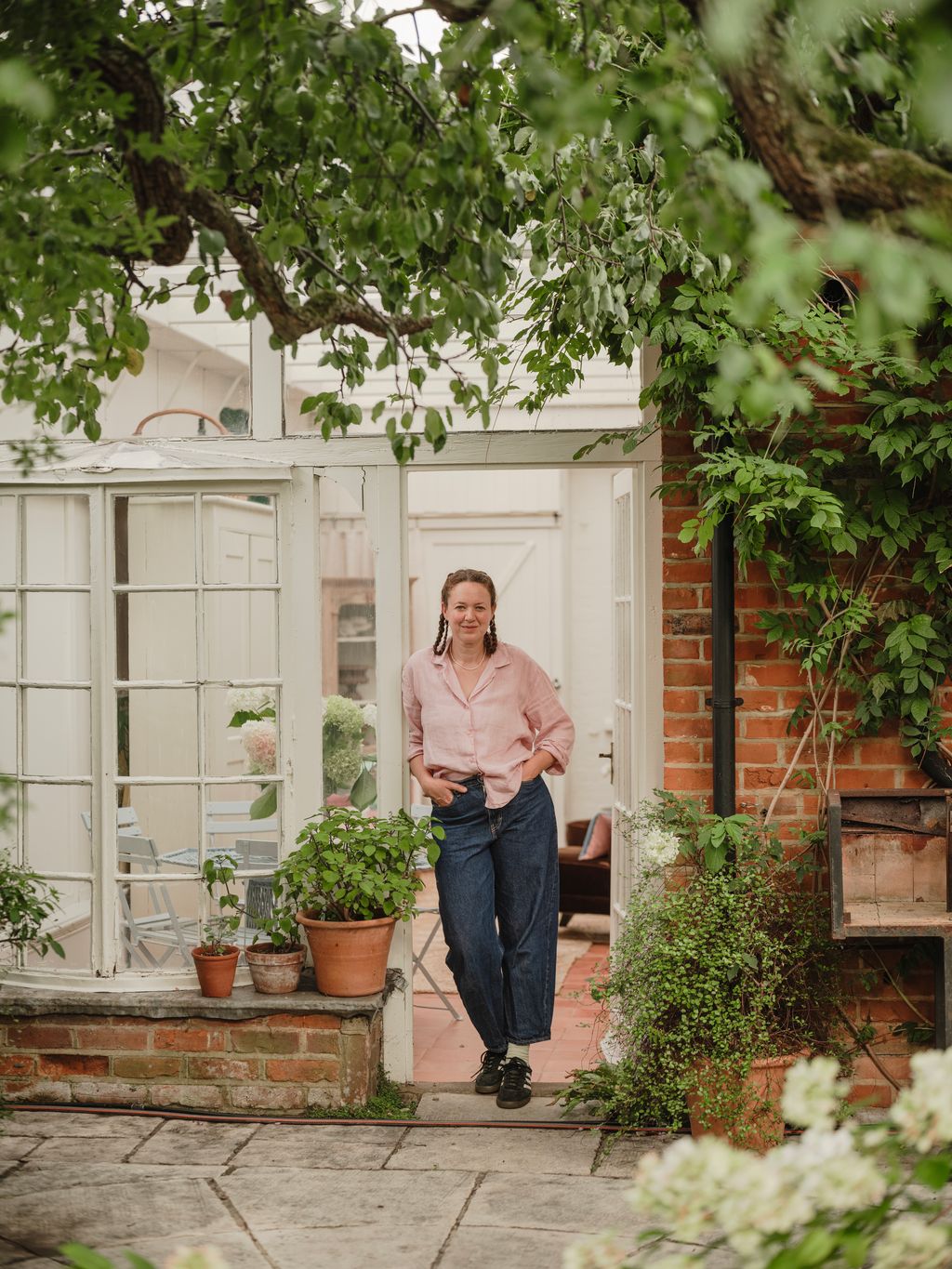 Image may contain Rachel Dolezal Clothing Pants Plant Potted Plant Herbal Herbs Jar Planter Pottery and Vase